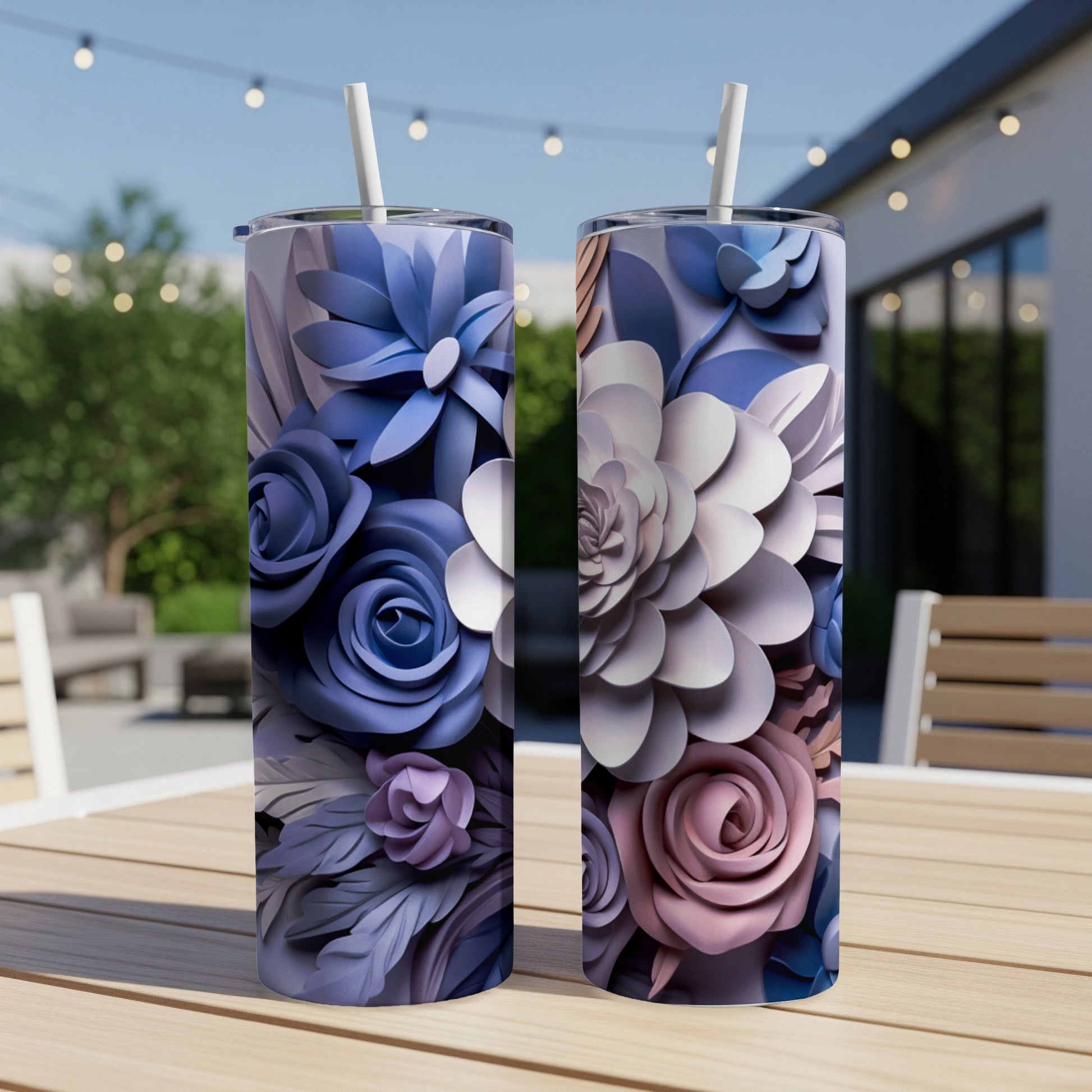 Two tumblers with floral designs sit on a wooden table.