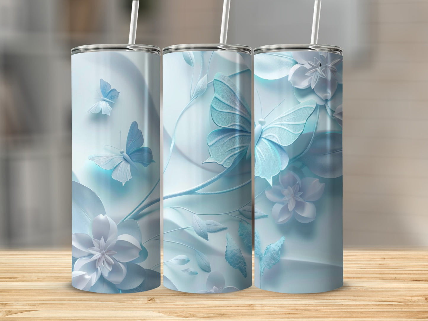 Three pale blue tumblers with raised floral and butterfly designs.