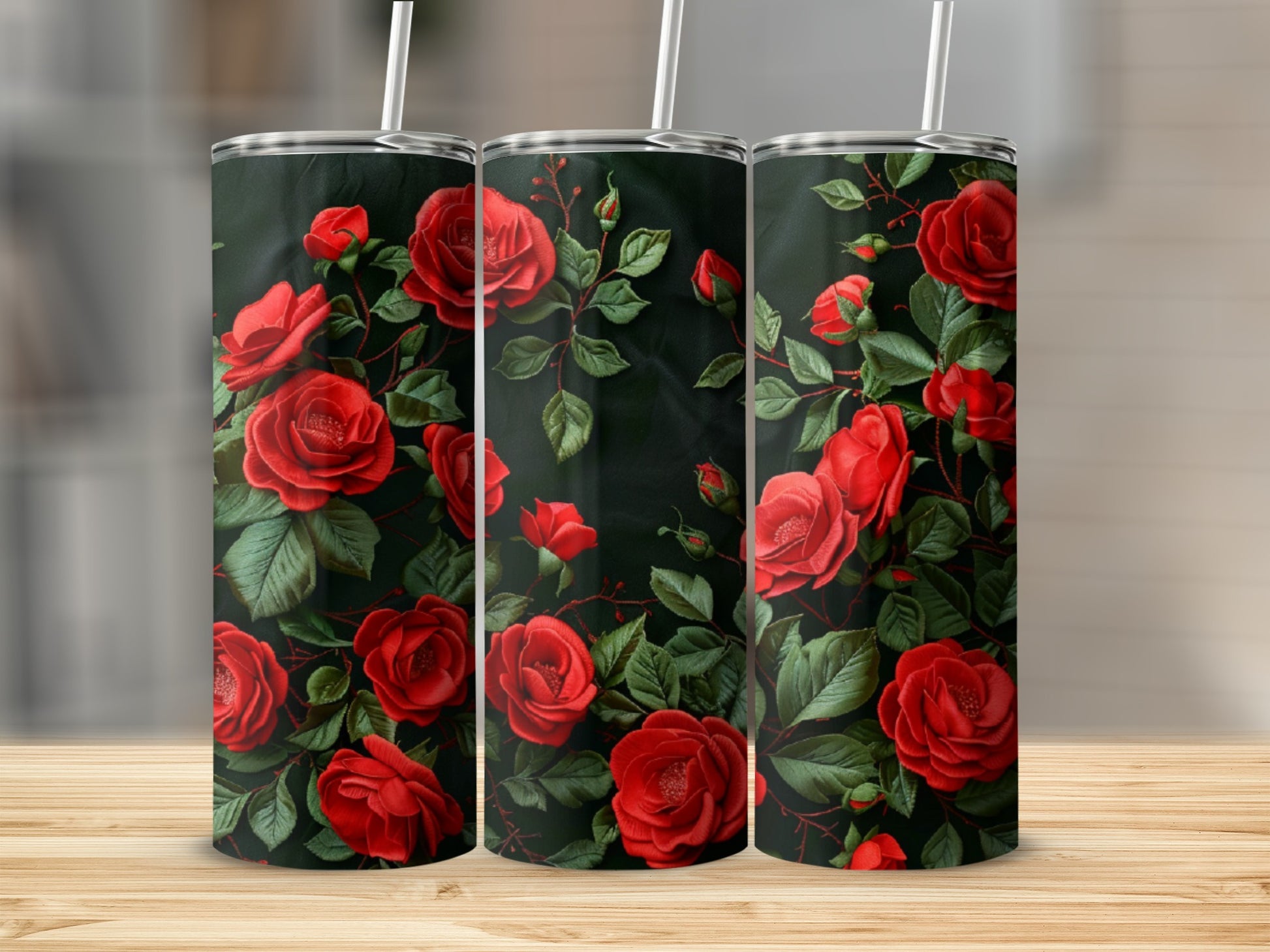 Three tumblers decorated with red roses and dark green leaves.