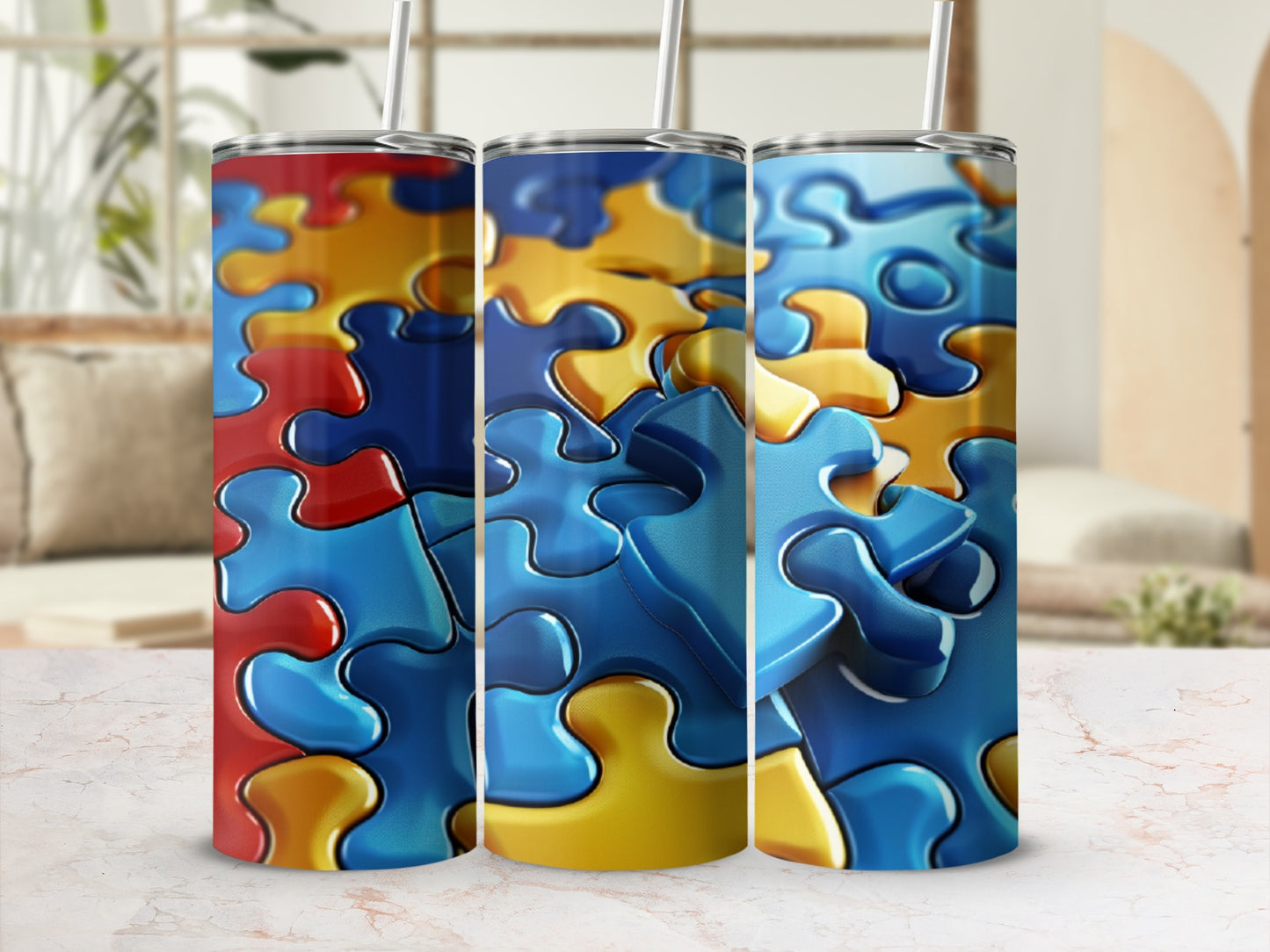 Three tumblers with a red, yellow, and blue puzzle piece design.