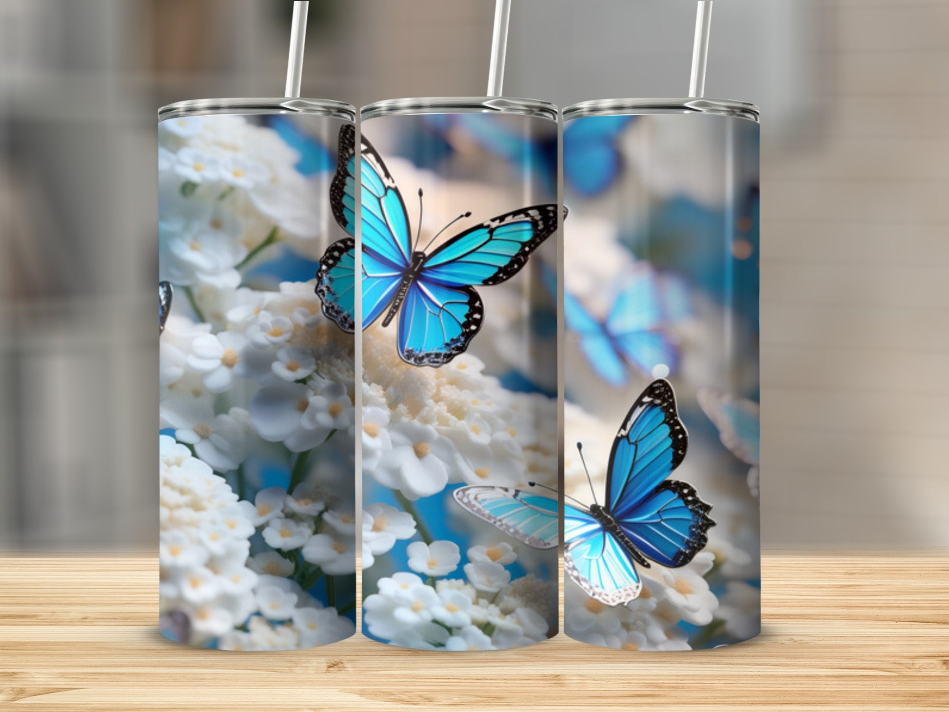 Three blue butterflies on white flowers, shown on tumblers.