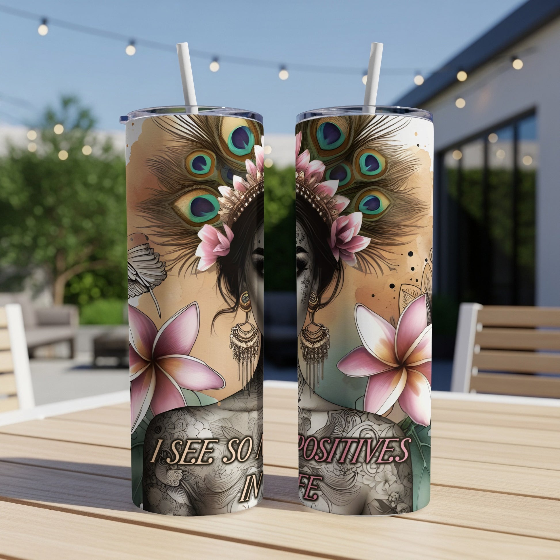 Two tumblers with a woman's face, peacock feathers, flowers, and text.