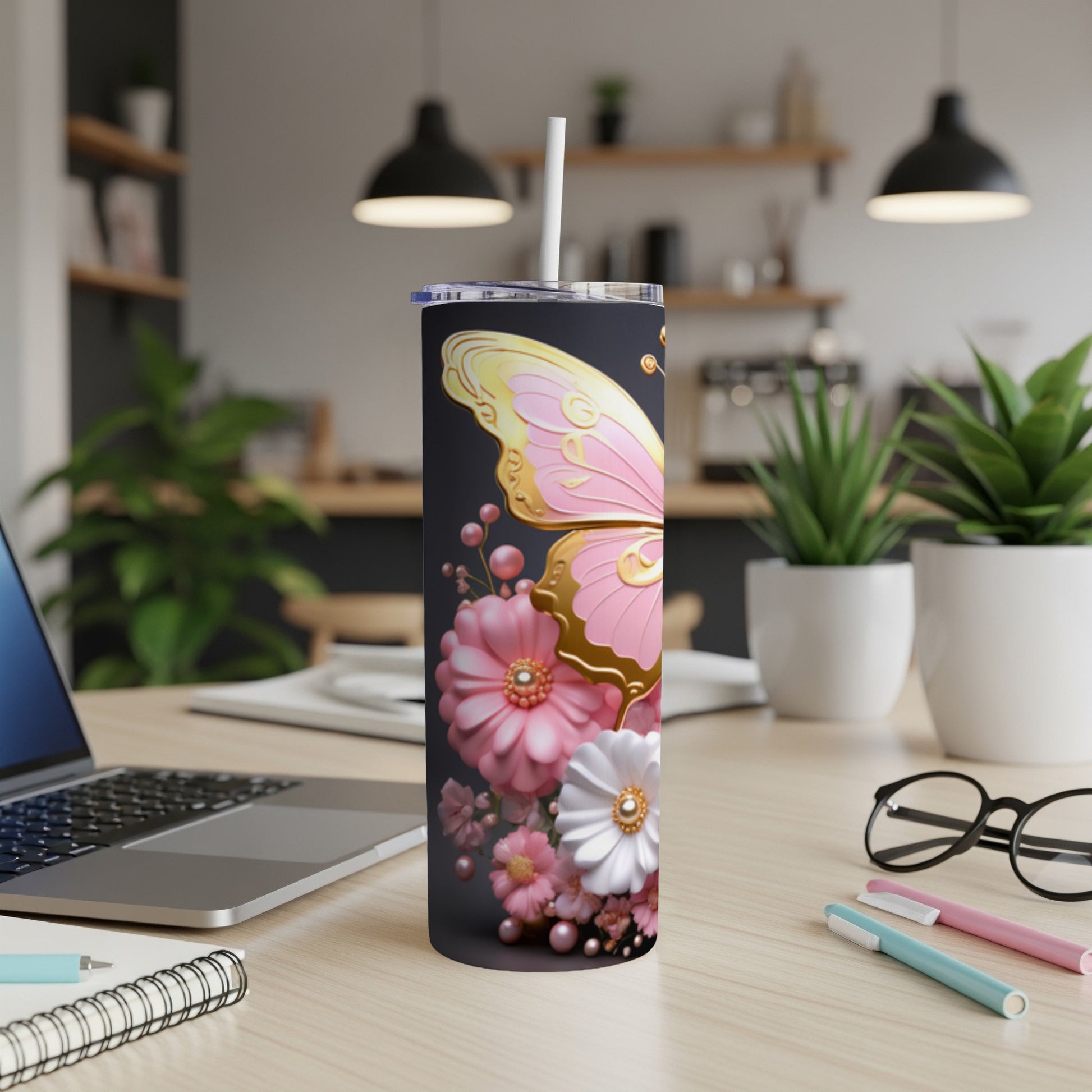 Pink butterfly and floral design on a black tumbler with a straw.