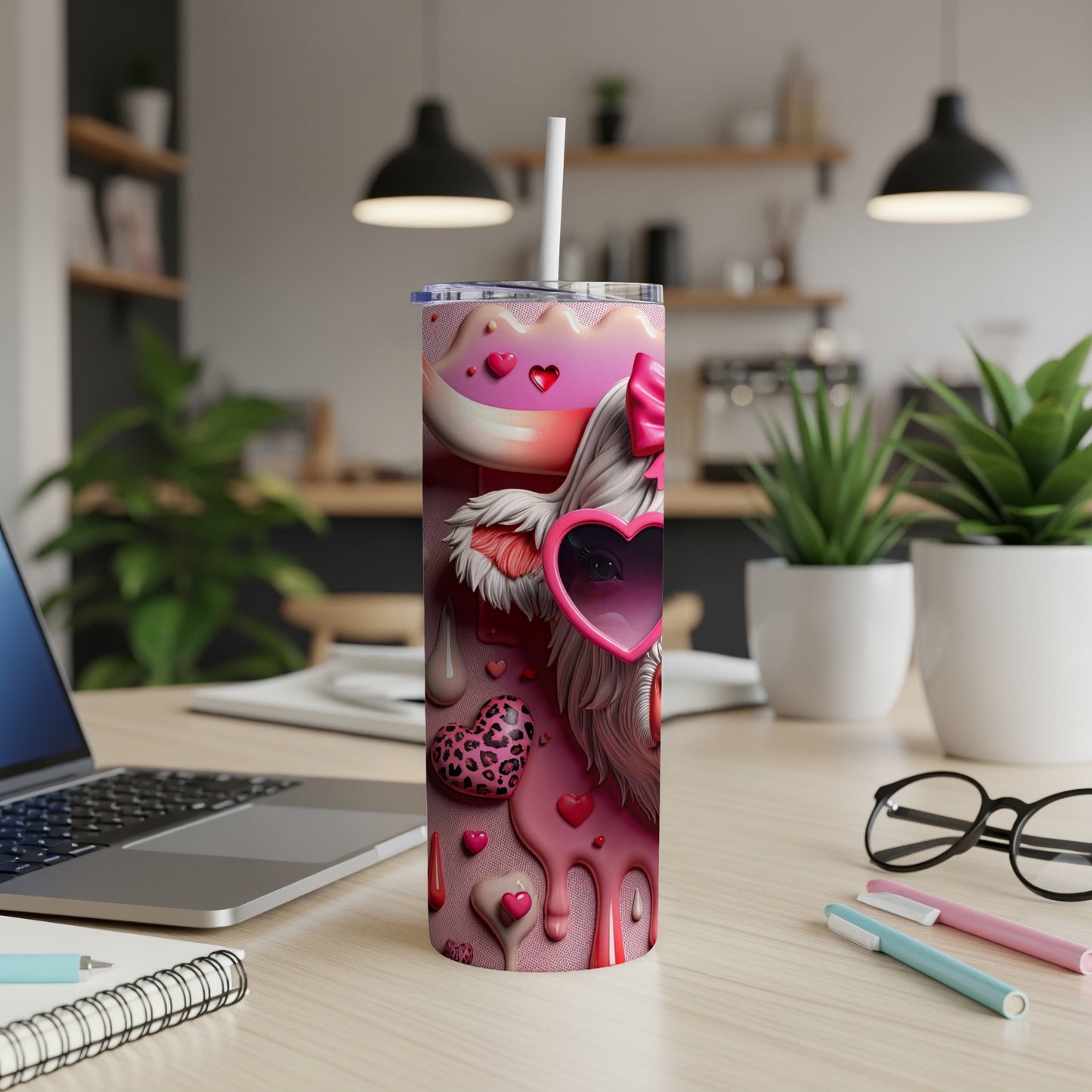 Pink Valentine's Day tumbler with hearts, drips, and sunglasses, on a desk.