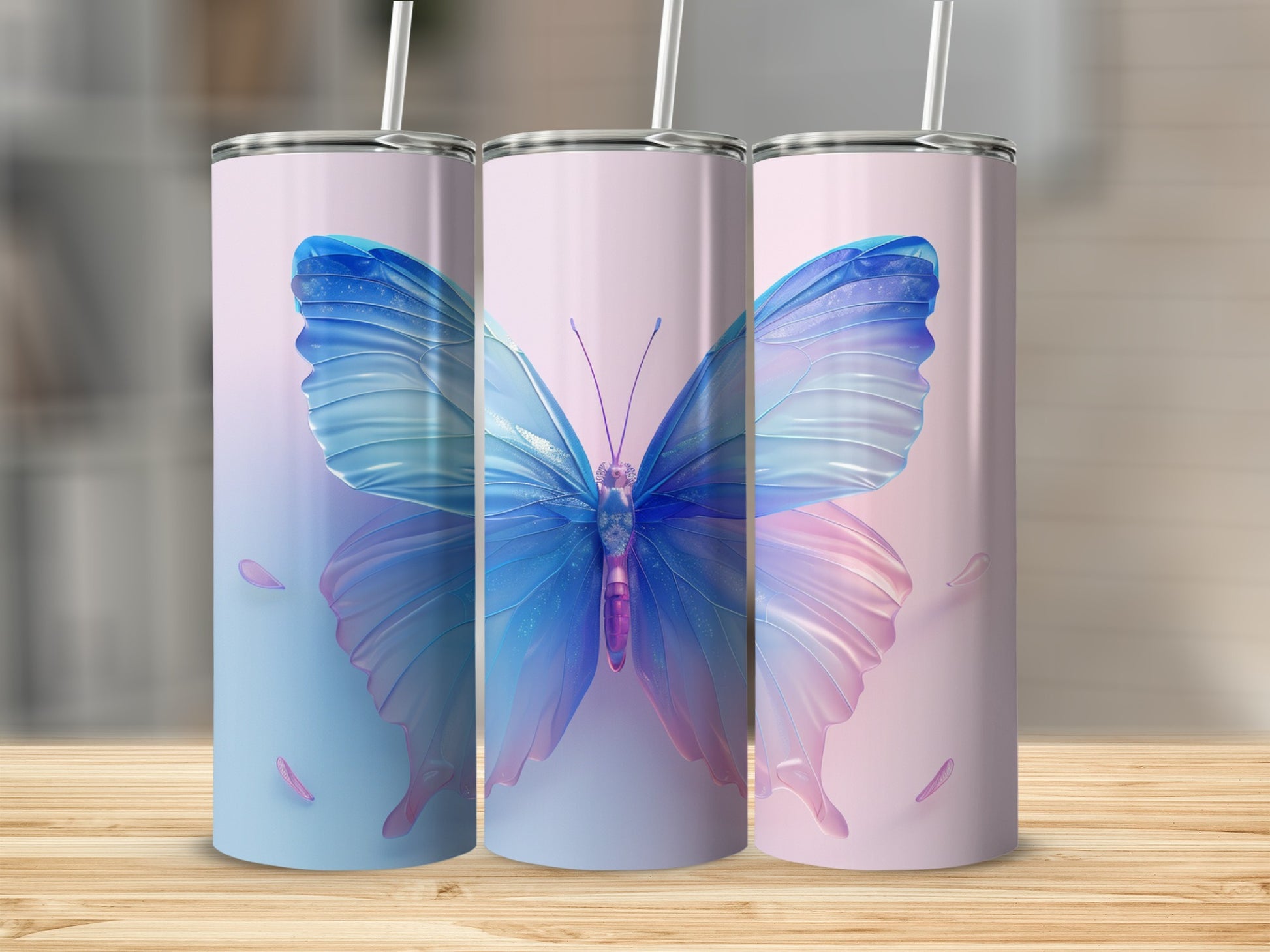 Pink and blue butterfly design on three tall, slim tumblers with straws.