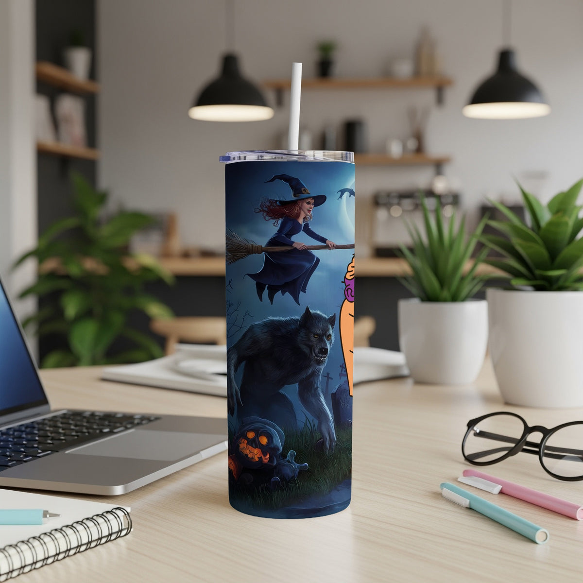 Tumbler with Halloween art featuring a witch on a broom and a werewolf in a graveyard.