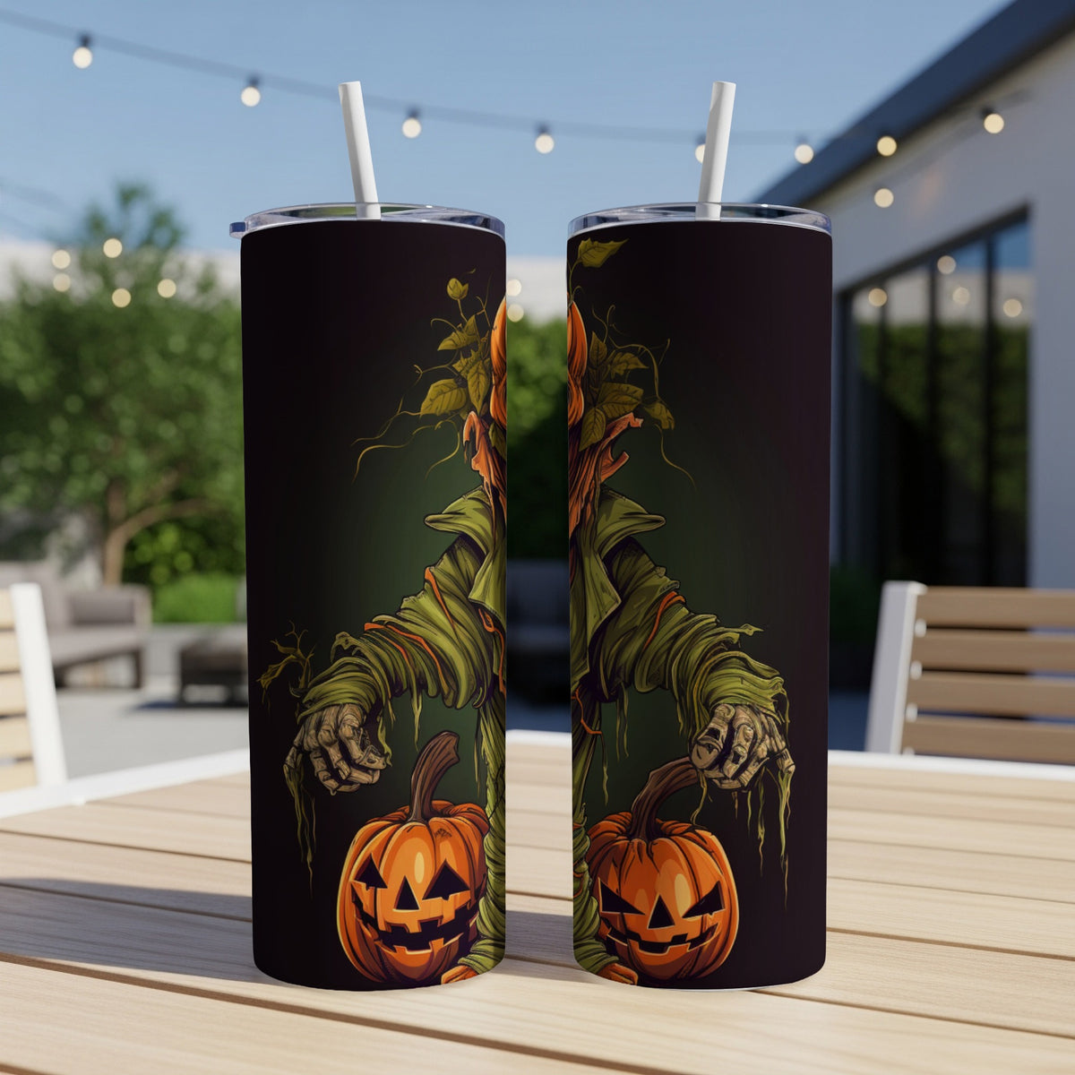 Two tumblers with a scarecrow and pumpkin design, featuring white straws.