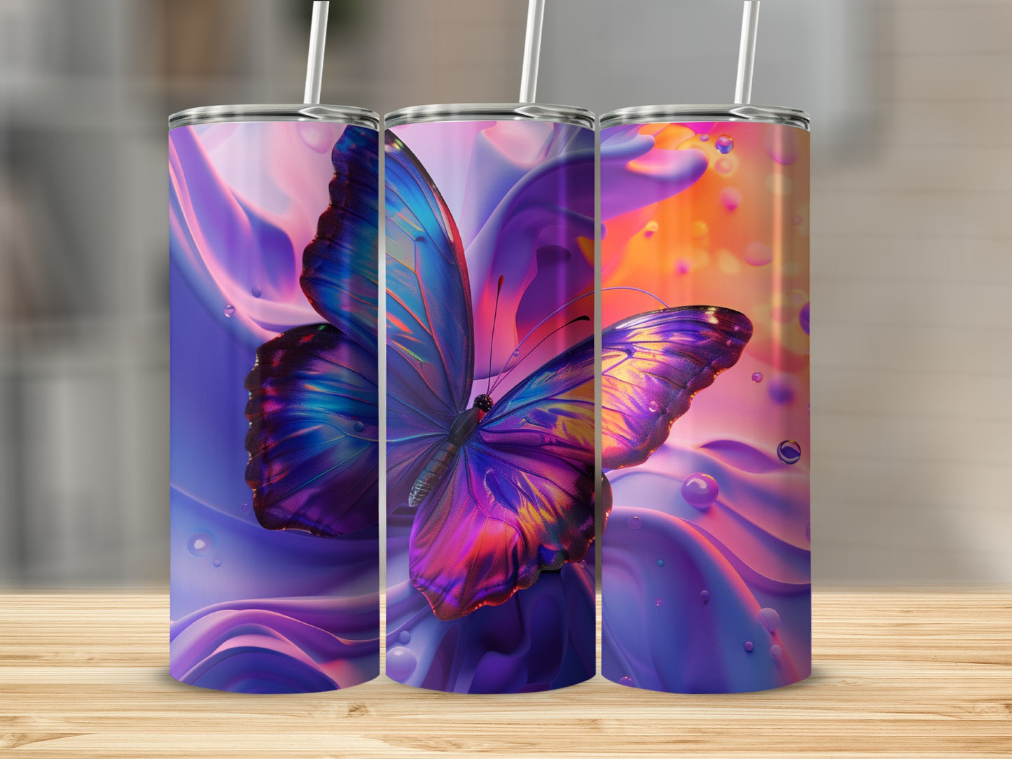 Three tumblers with vibrant butterfly and abstract liquid designs.