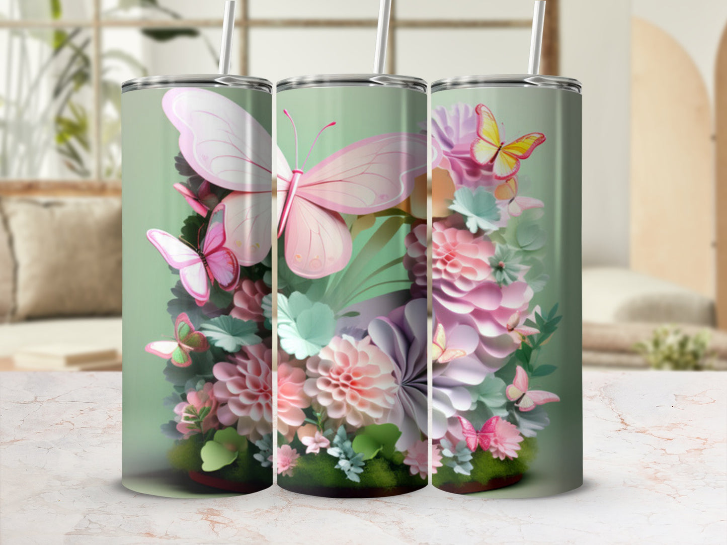 Three tumblers with pink butterflies and floral designs on a soft green background.