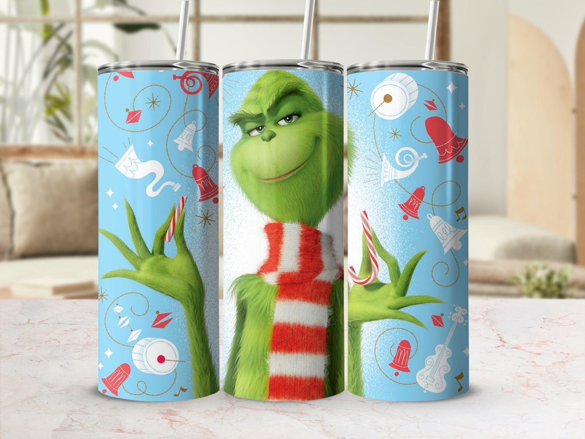 Grinch wearing a striped scarf and holding candy canes on a teal tumbler.