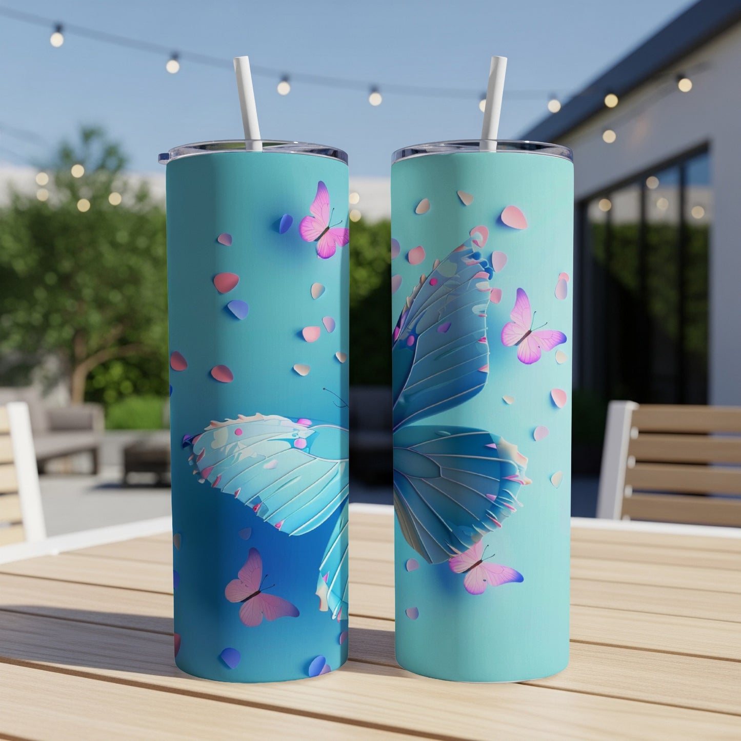 Two teal tumblers with blue and pink butterflies and petals.