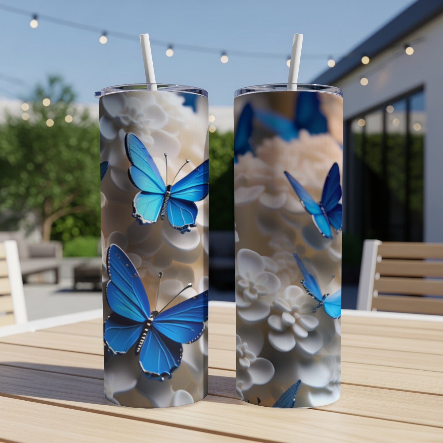 Two tall tumblers with blue butterflies on a floral pattern.