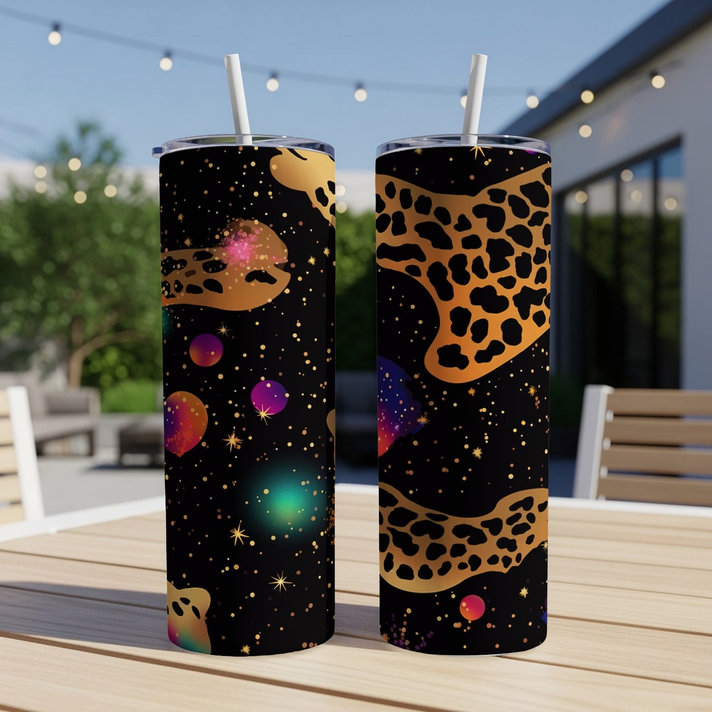 Two black tumblers with colorful galaxy and leopard print patterns.