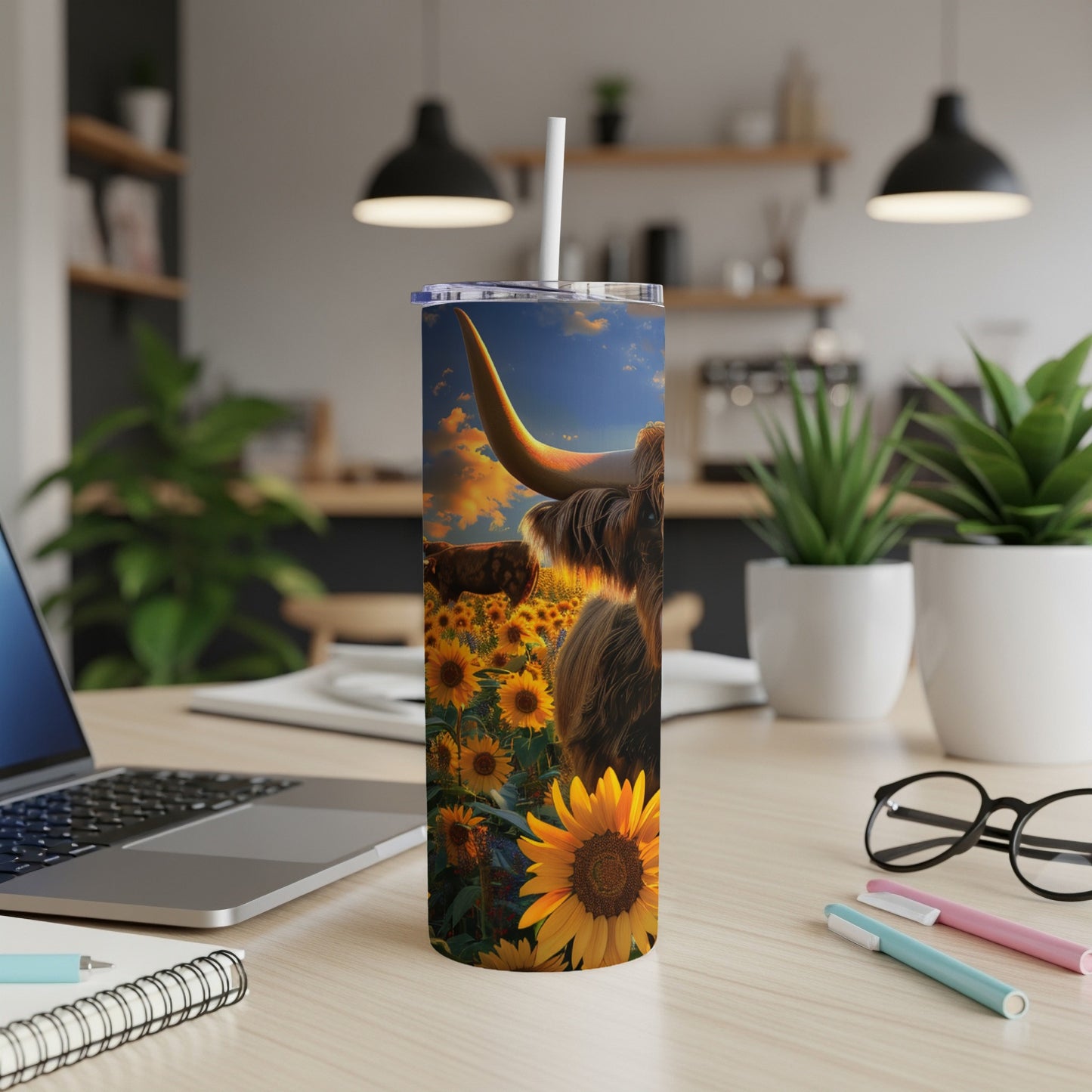 Highland cow in sunflower field on a travel tumbler.