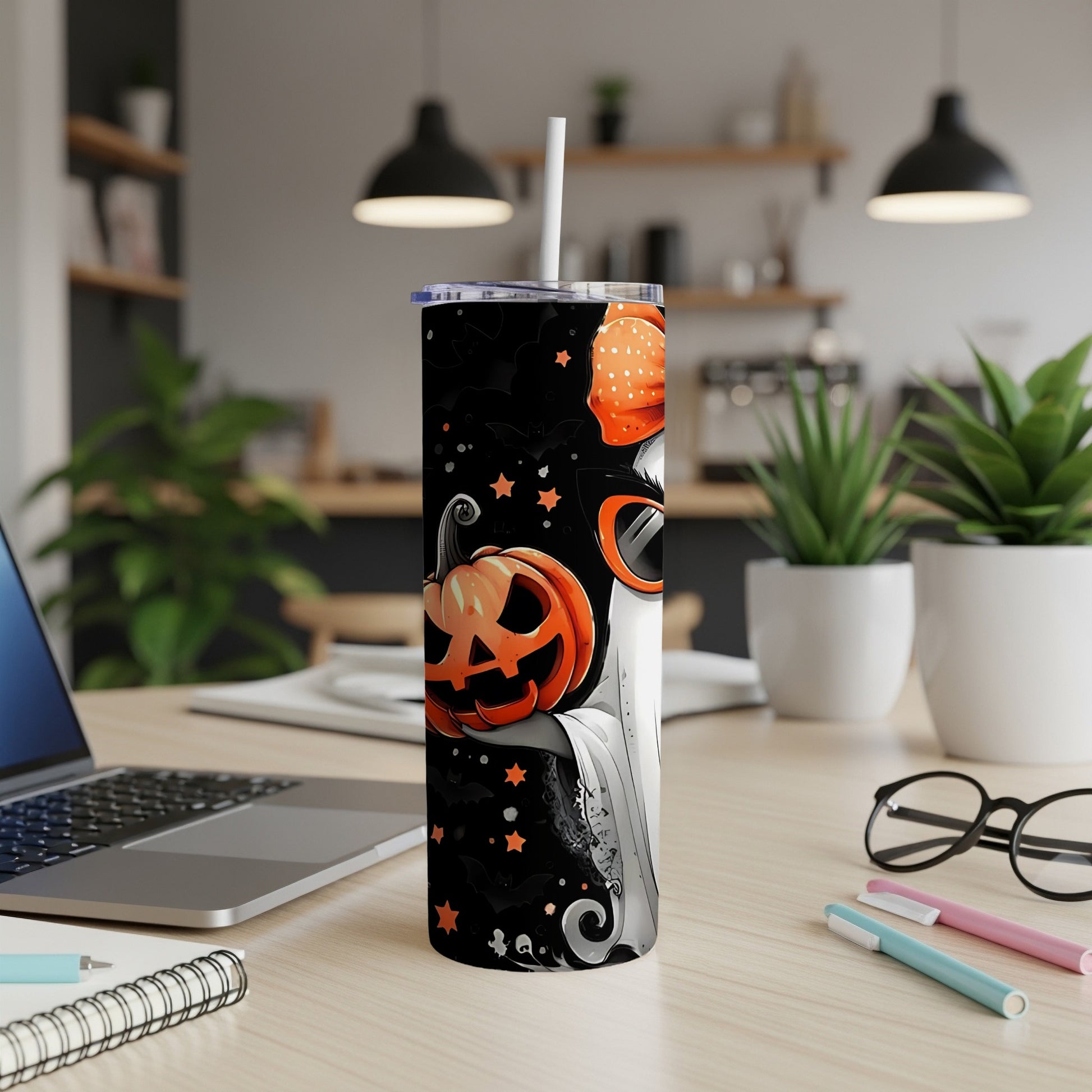 Halloween tumbler with pumpkin and ghost design on black background.