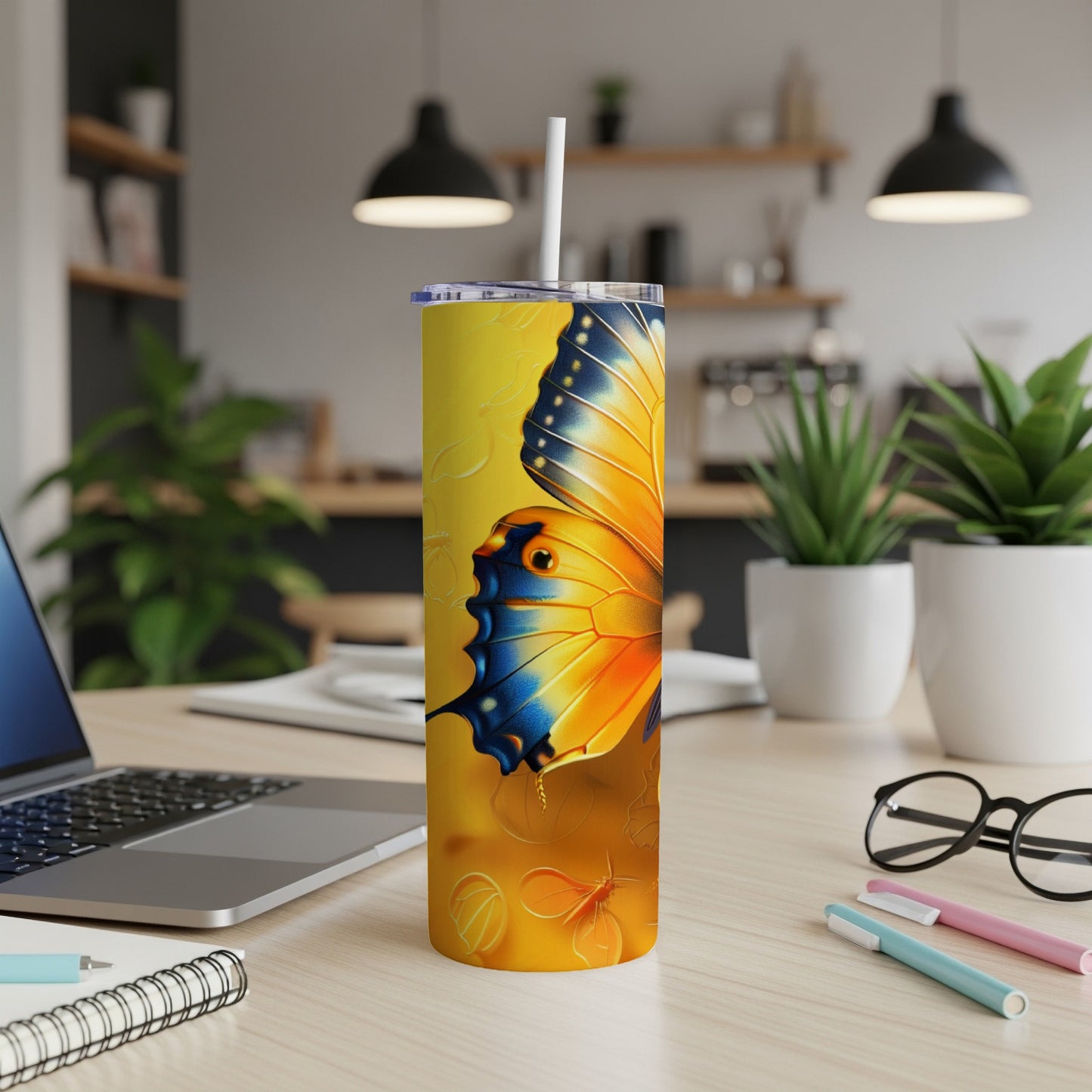 Yellow tumbler with a large orange and blue butterfly design.