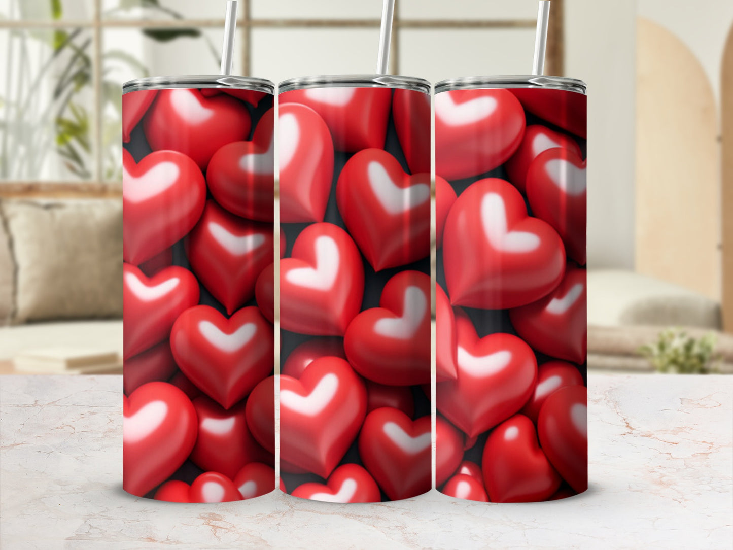 Three tumblers with a pattern of red heart shapes on a light surface.