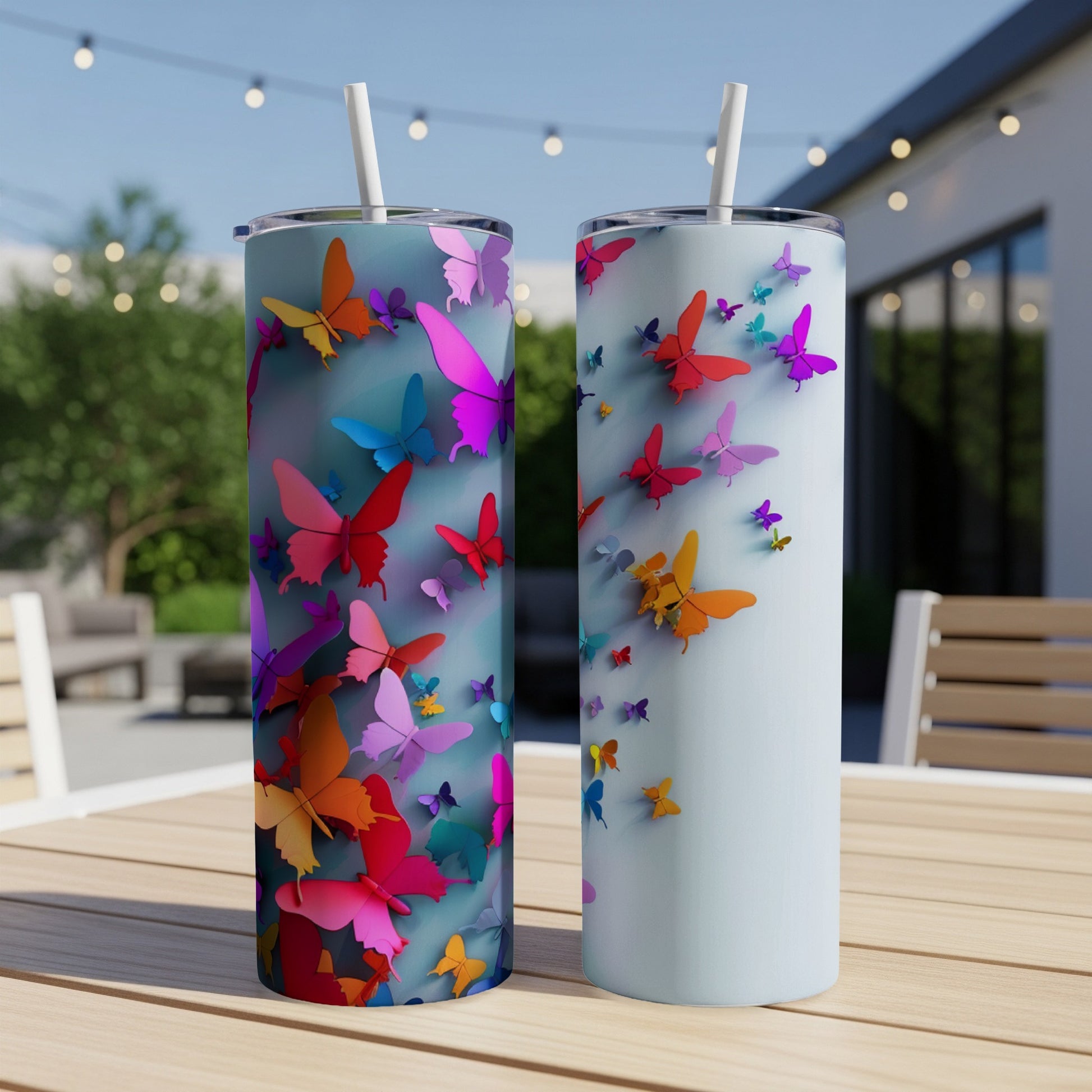 Two tumblers with colorful butterflies scattered across them.