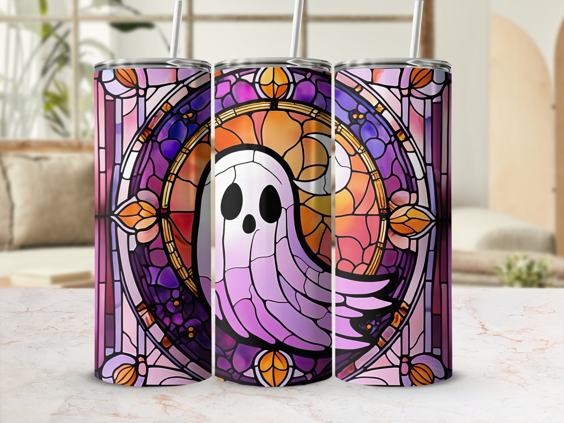 Three tumblers decorated with a purple, pink, and orange stained glass ghost design.