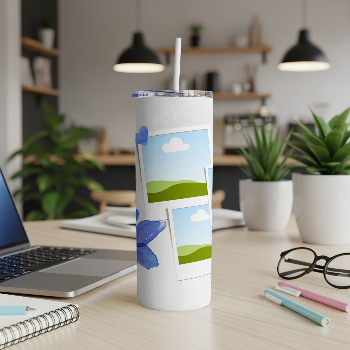 White tumbler with blue watercolor butterfly and polaroid-style photo frames.