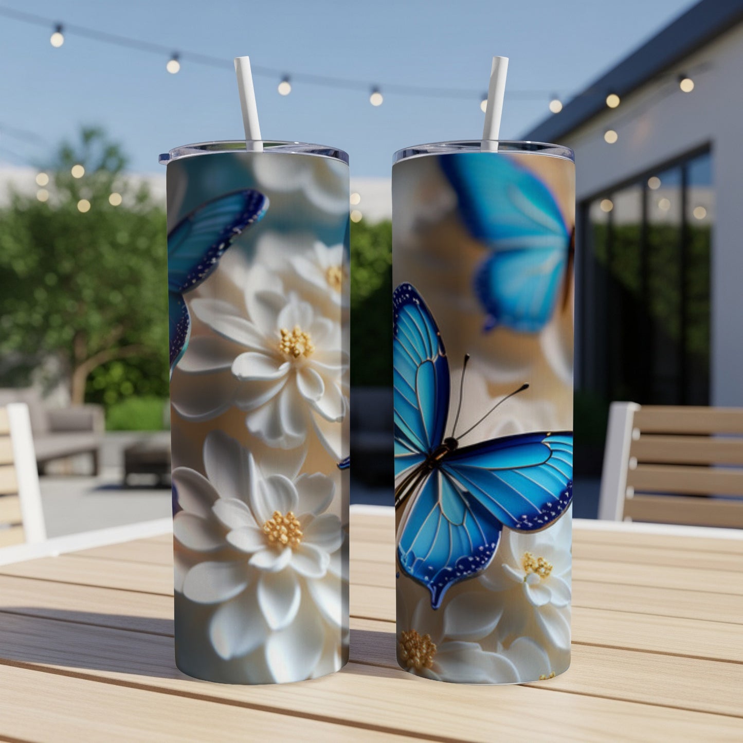 Two tall tumblers with blue butterflies and white flowers.