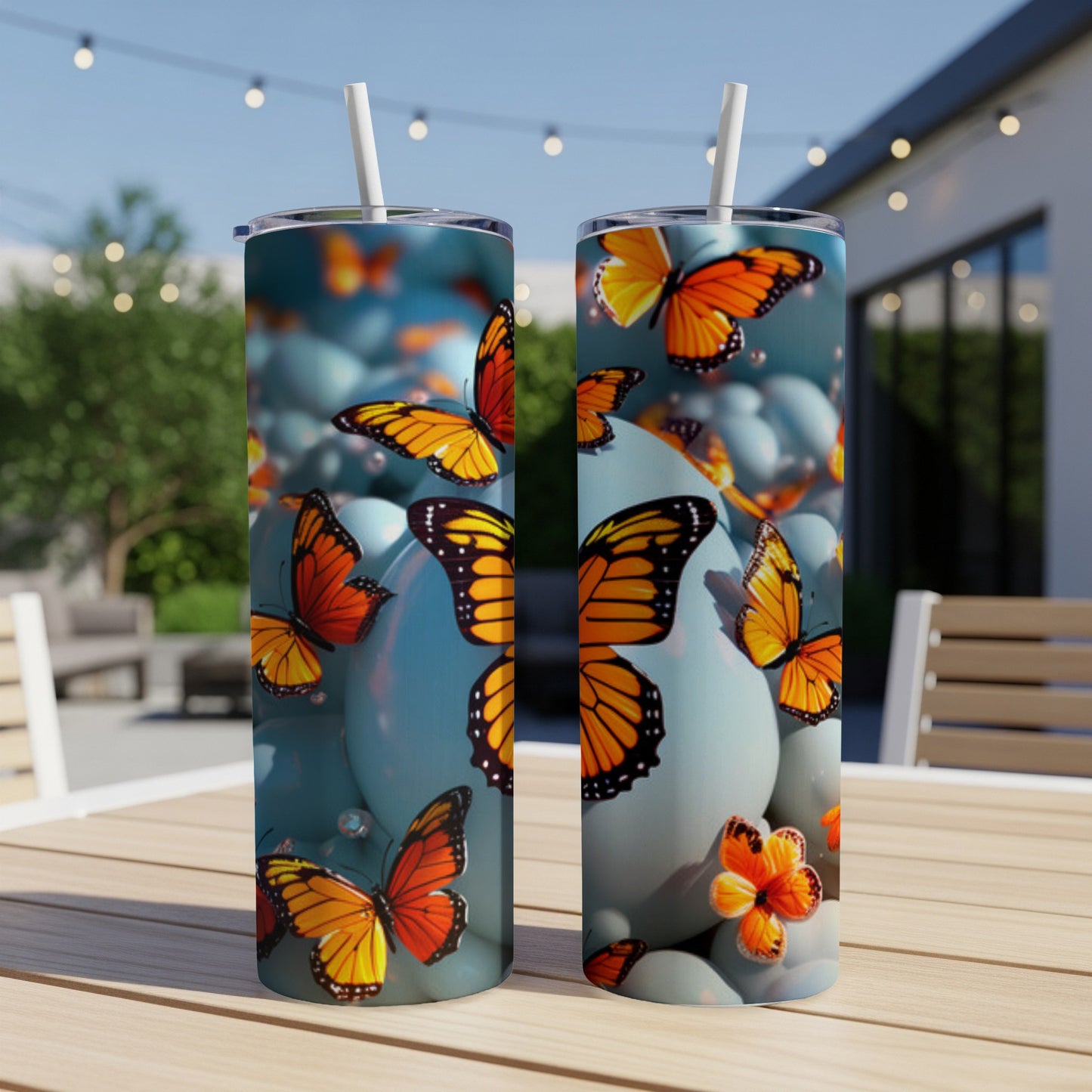 Two tall tumblers with orange butterflies and blue eggs design.