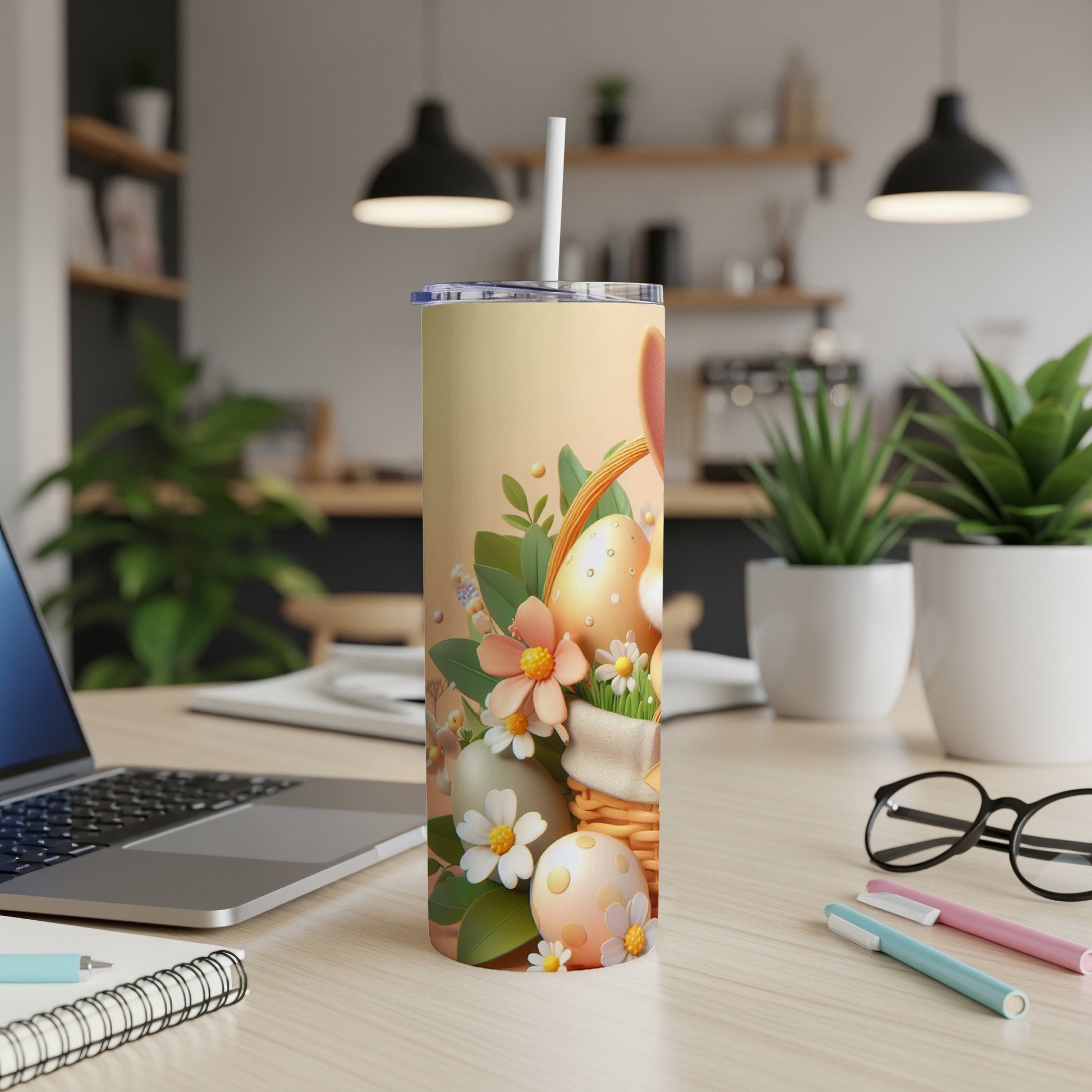 Easter egg tumbler with straw on a desk with a laptop.