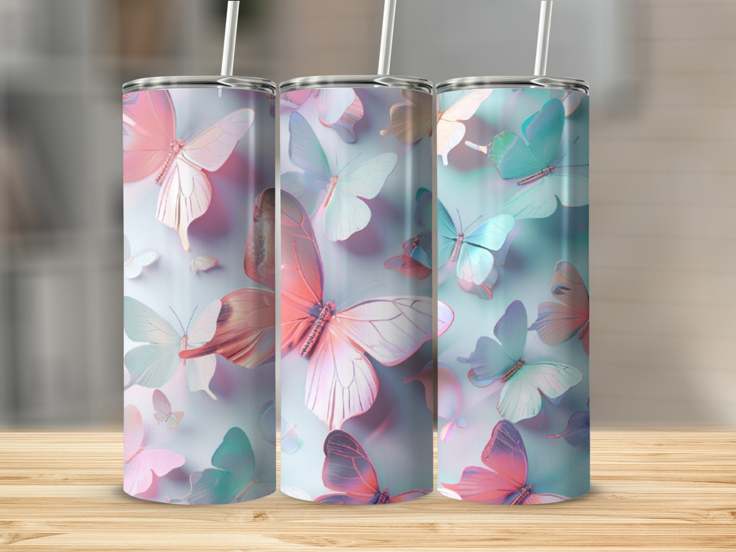 Three tall tumblers with a colorful butterfly design.