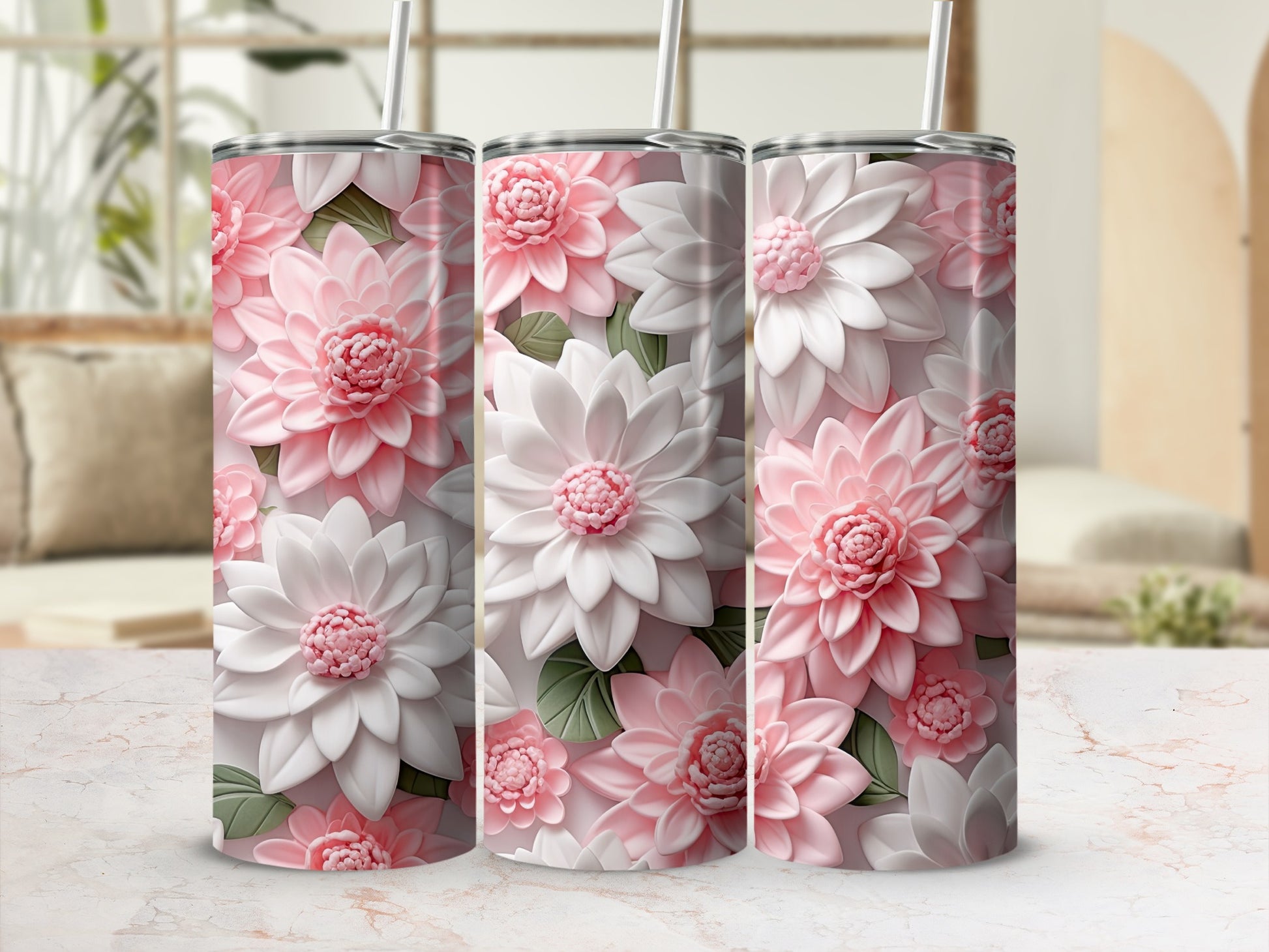 Three floral tumblers with 3D pink and white flowers on a marble surface.