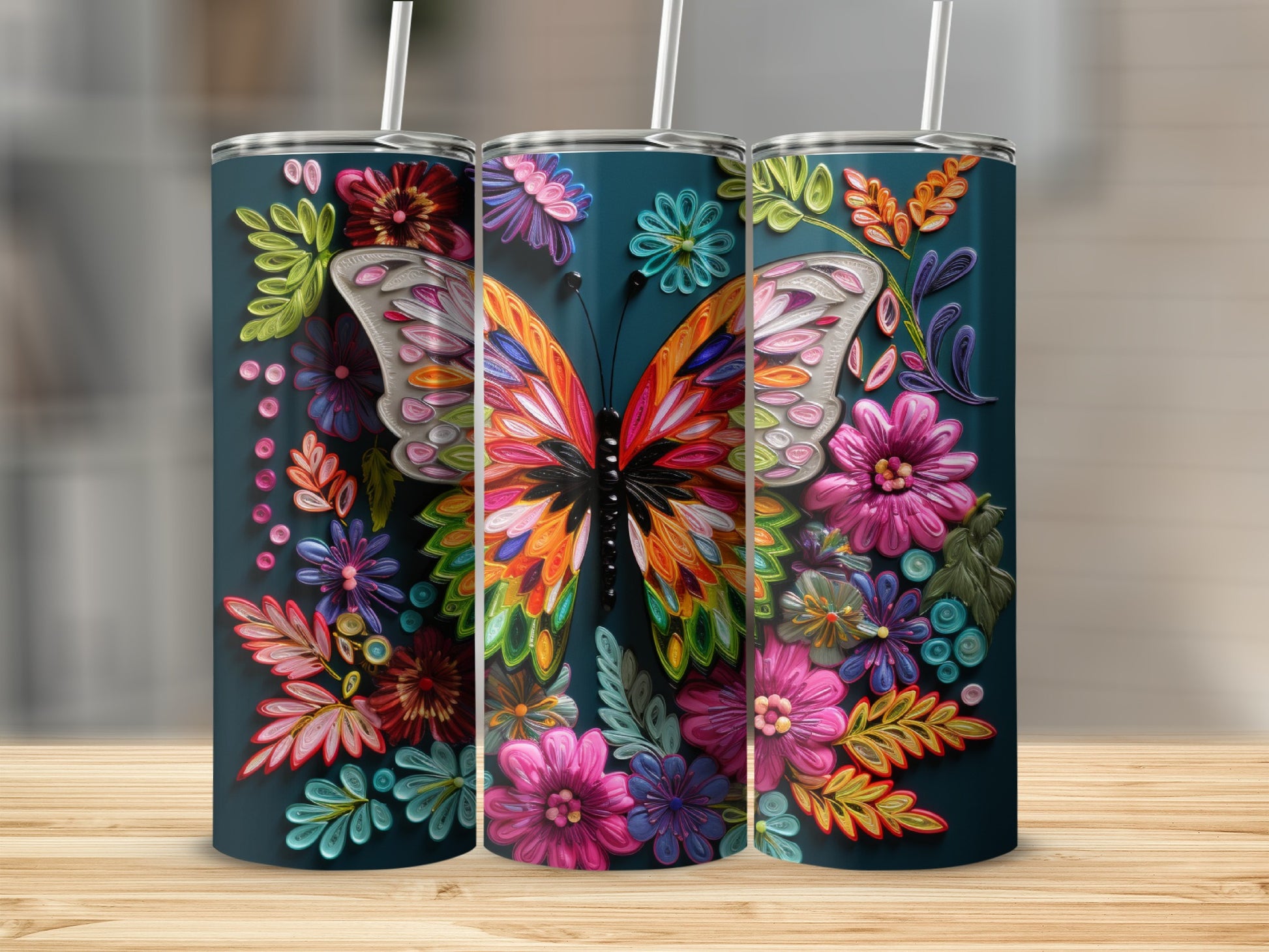 Three tumblers featuring a colorful butterfly and floral designs.