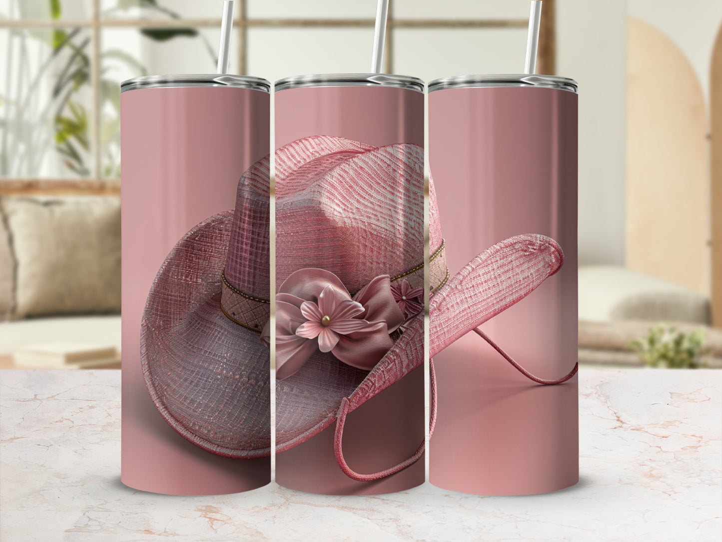 Pink cowboy hat with flower detail on a decorative tumbler.