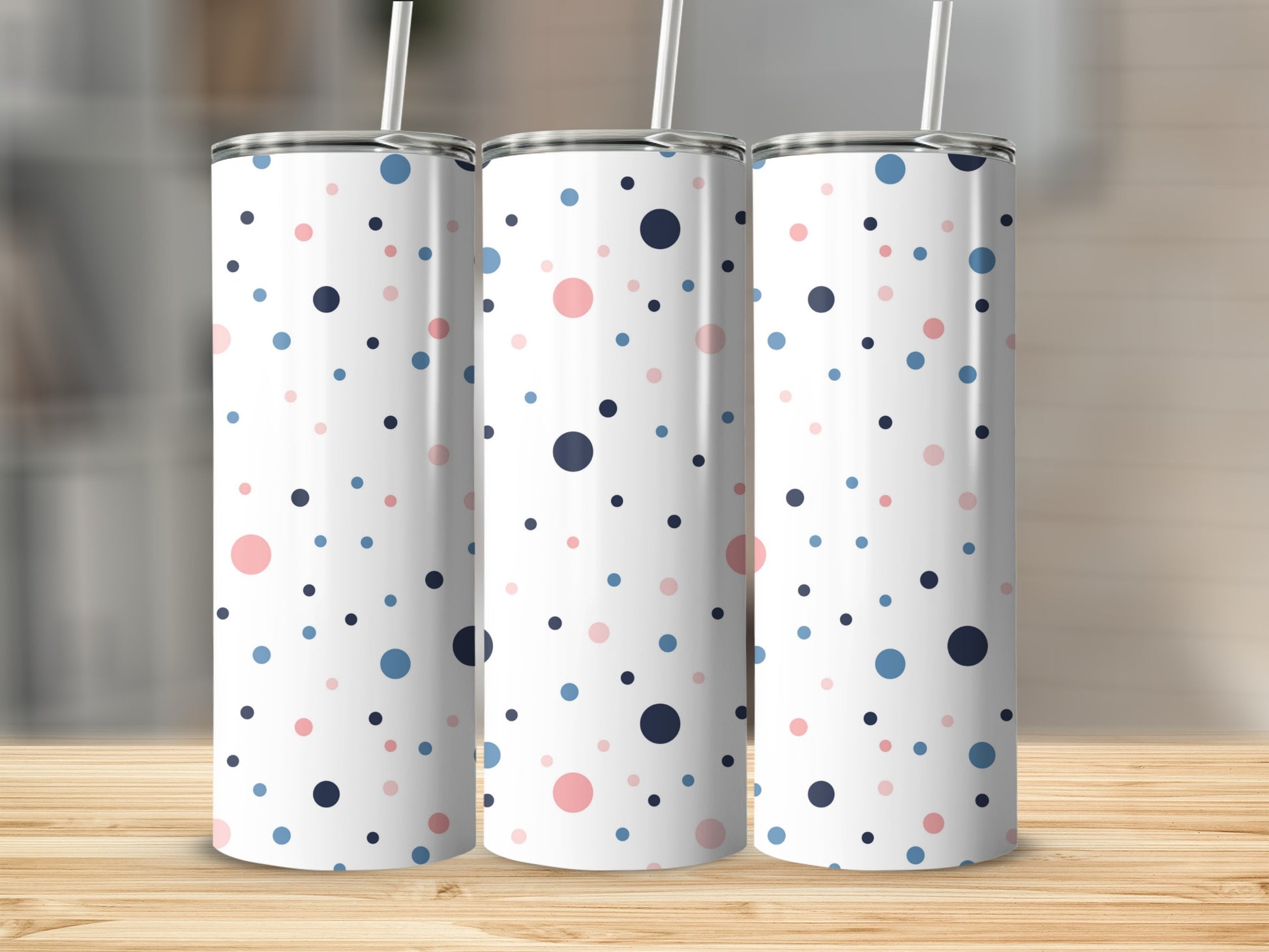 Three tumblers with a white background and scattered pink, blue, and navy polka dots.
