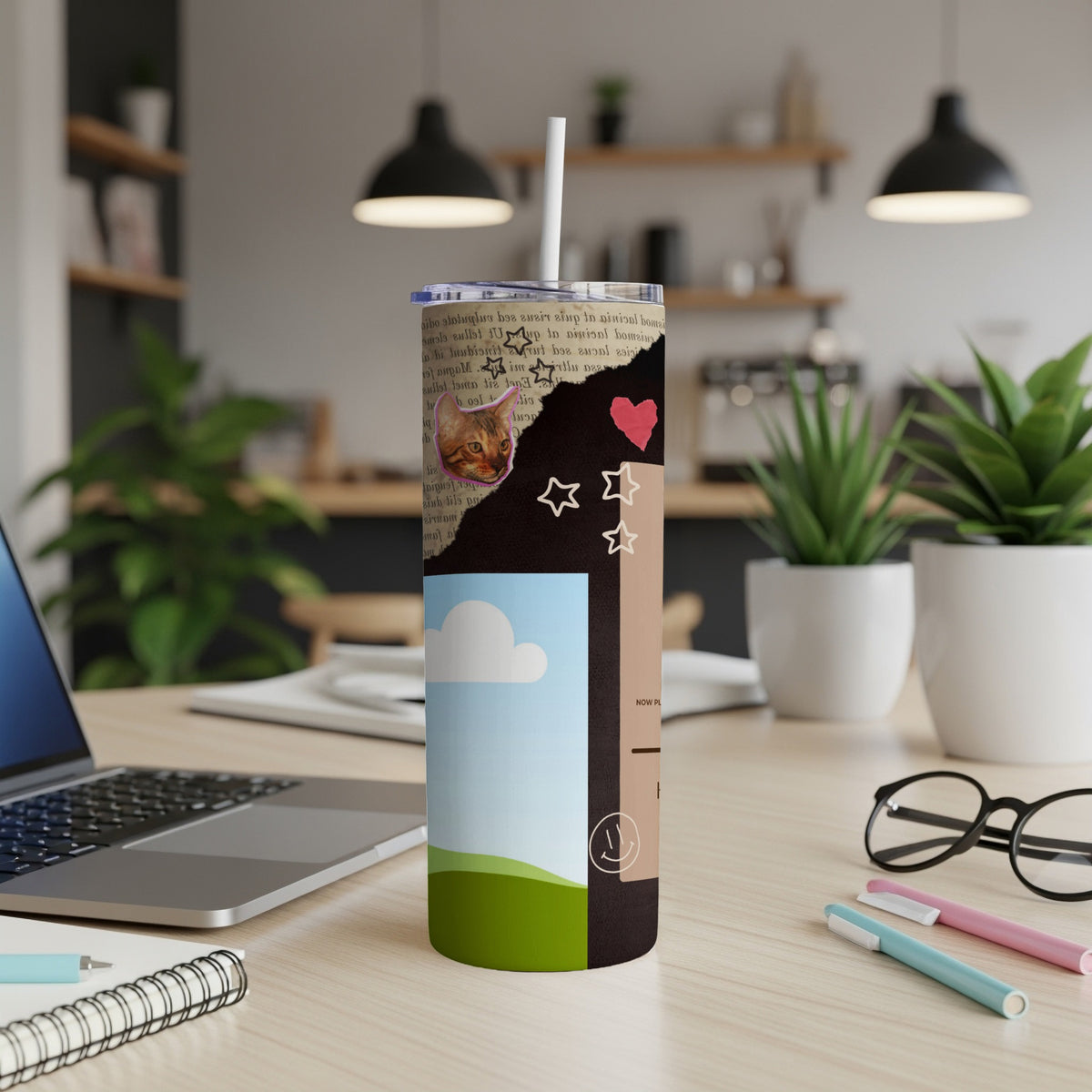 Collage tumbler with cat, stars, heart, and landscape design.