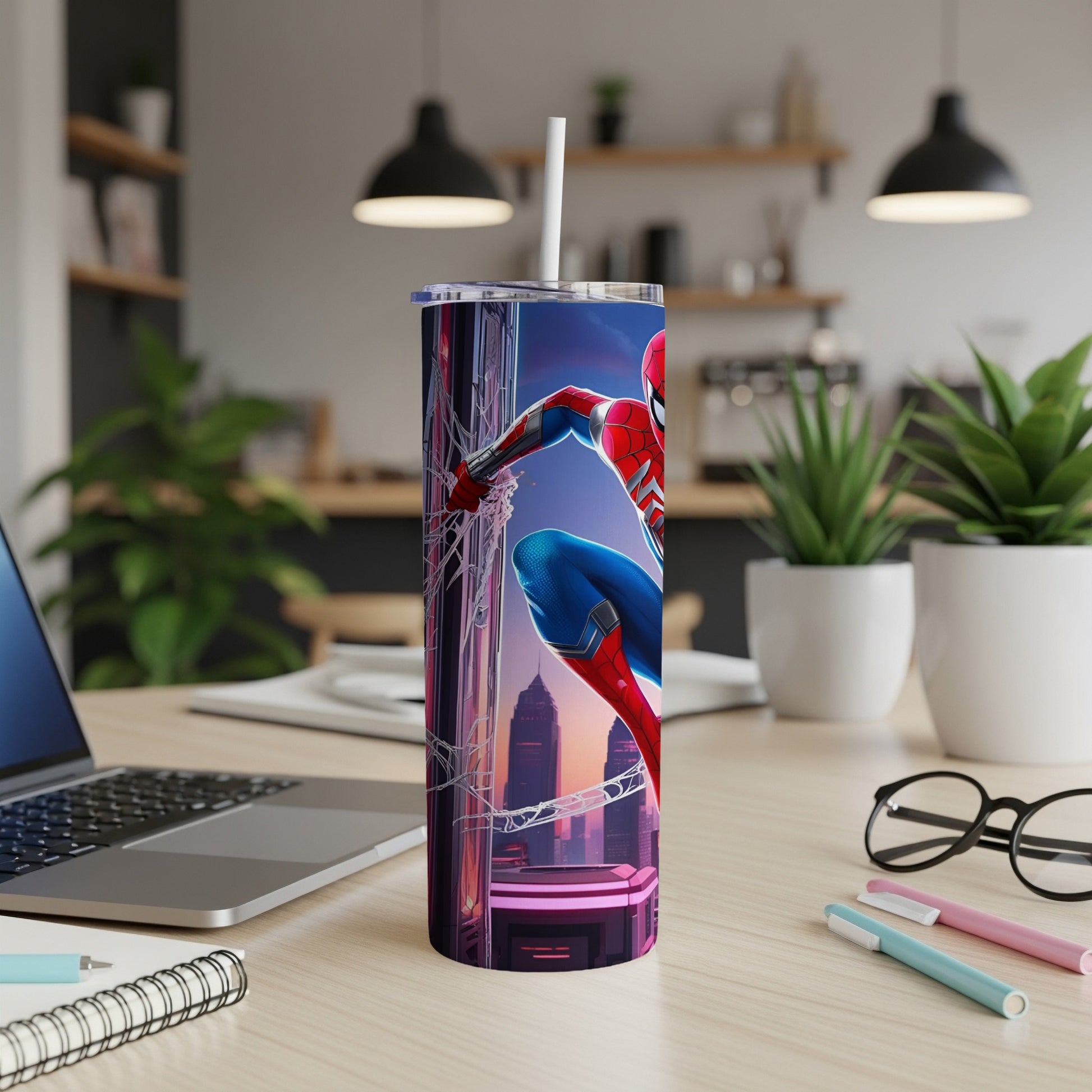 Spider-Man on a cityscape tumbler with a straw, on a desk.
