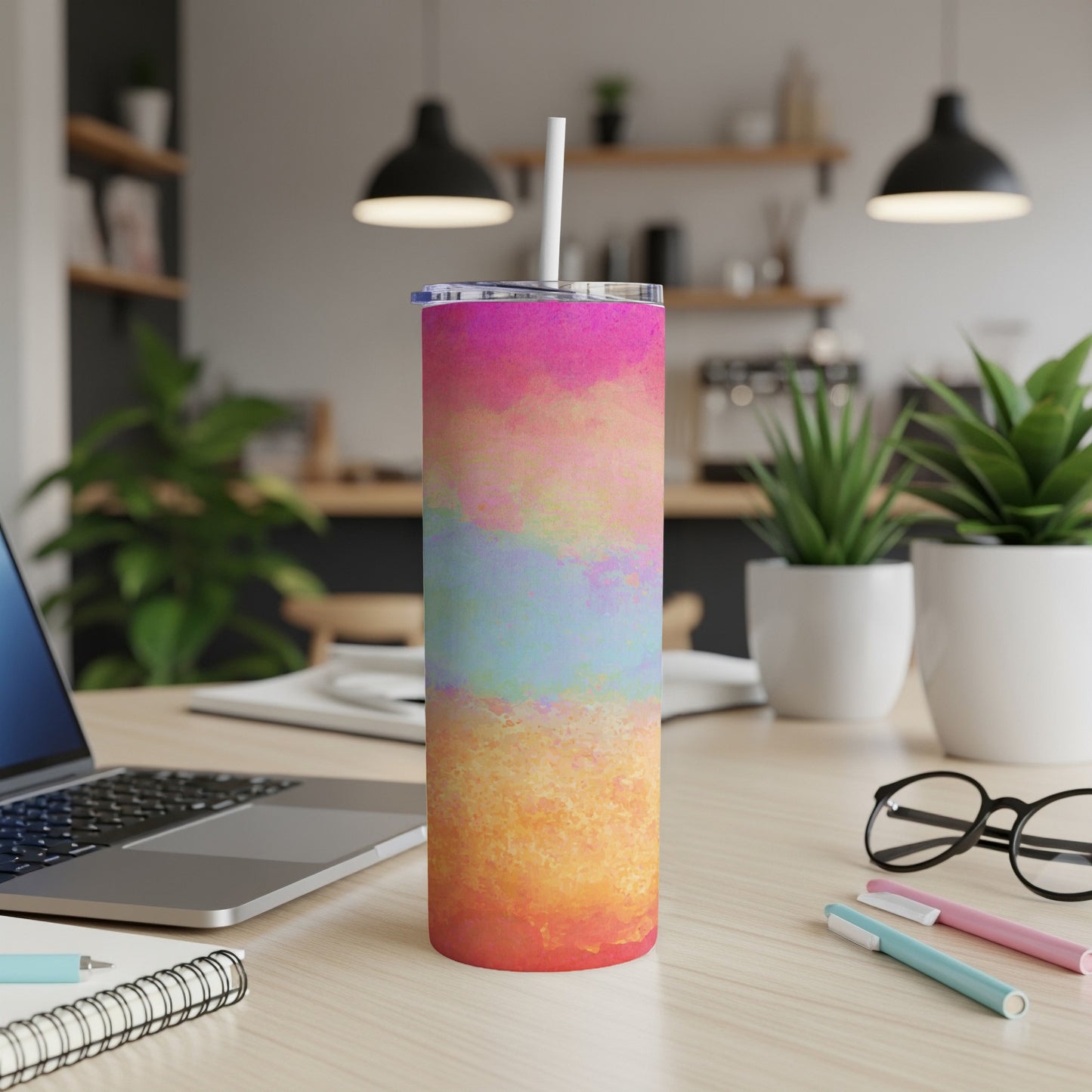 Tall tumbler with watercolor abstract design, white straw, and clear lid.