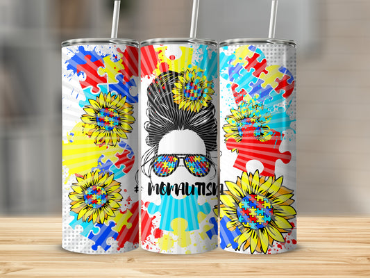 Tumbler with autism puzzle pieces, sunflowers, and "#MOMTAUTISM" text.