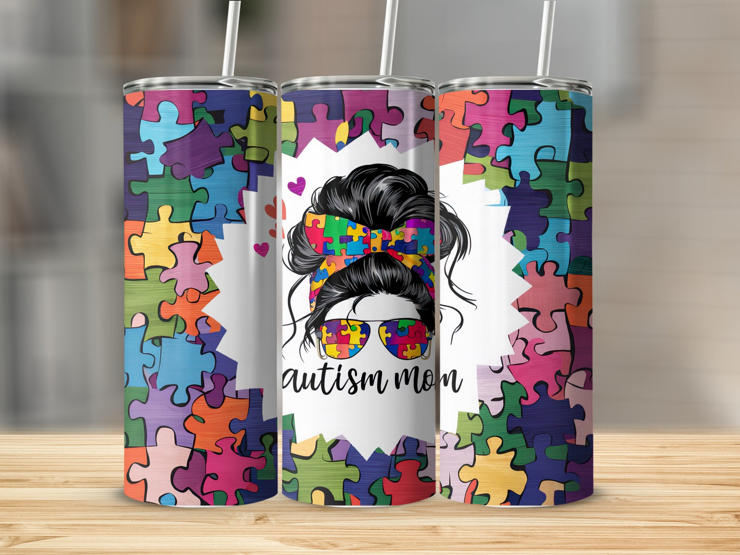Autism mom tumbler with colorful puzzle piece pattern and messy bun.