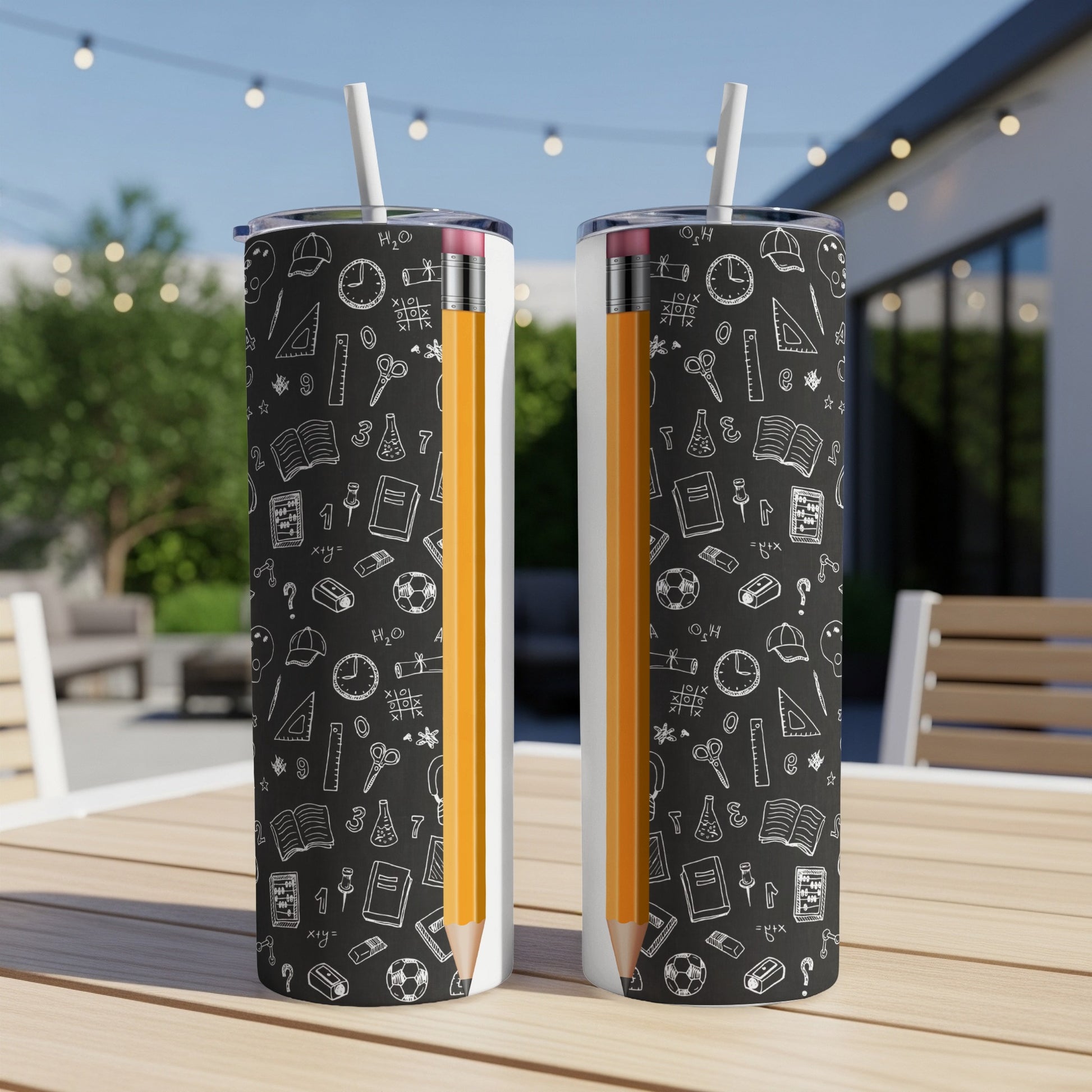 Two tumblers with a black chalkboard pattern featuring school doodles and a pencil.