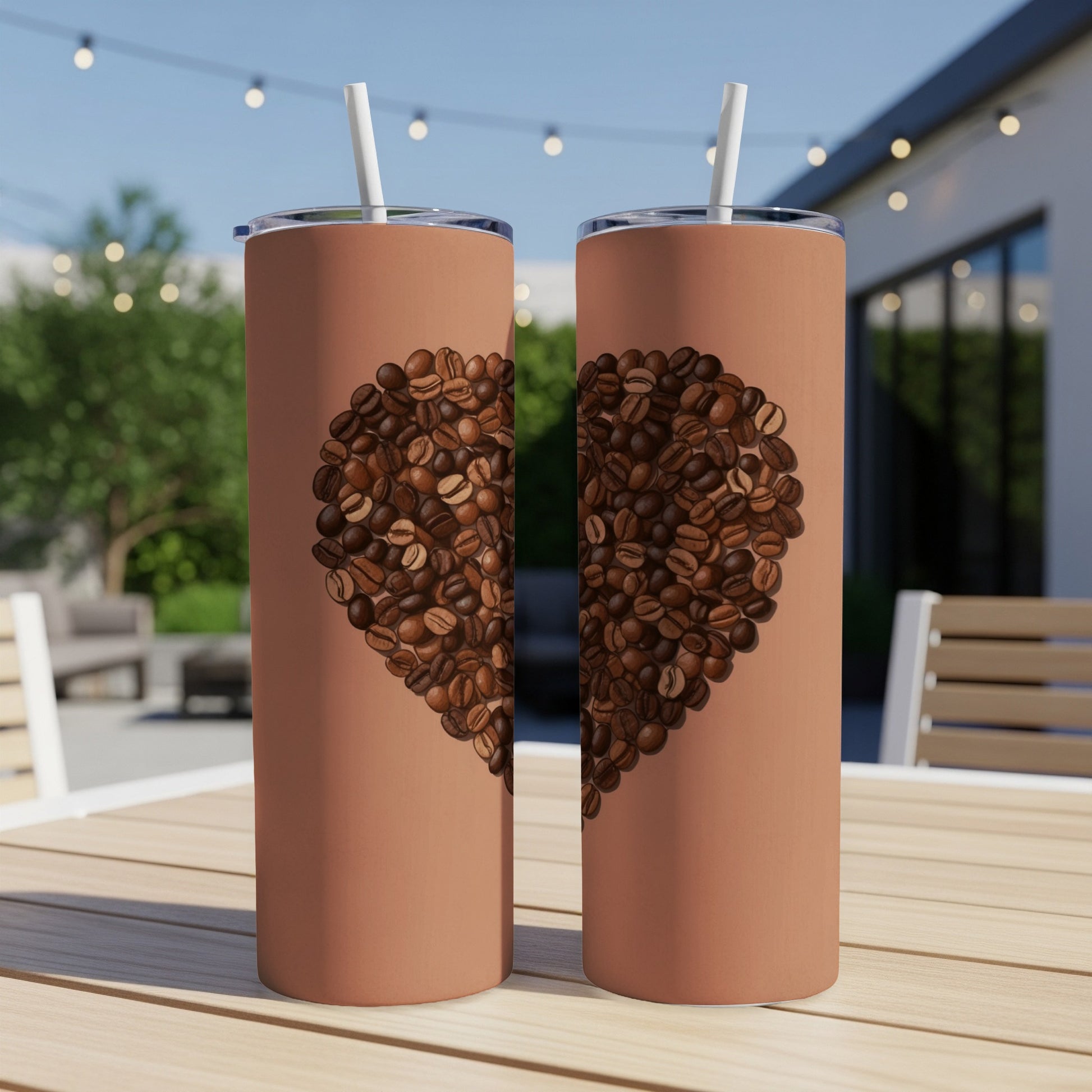 Two tumblers with a heart of coffee beans on a table.