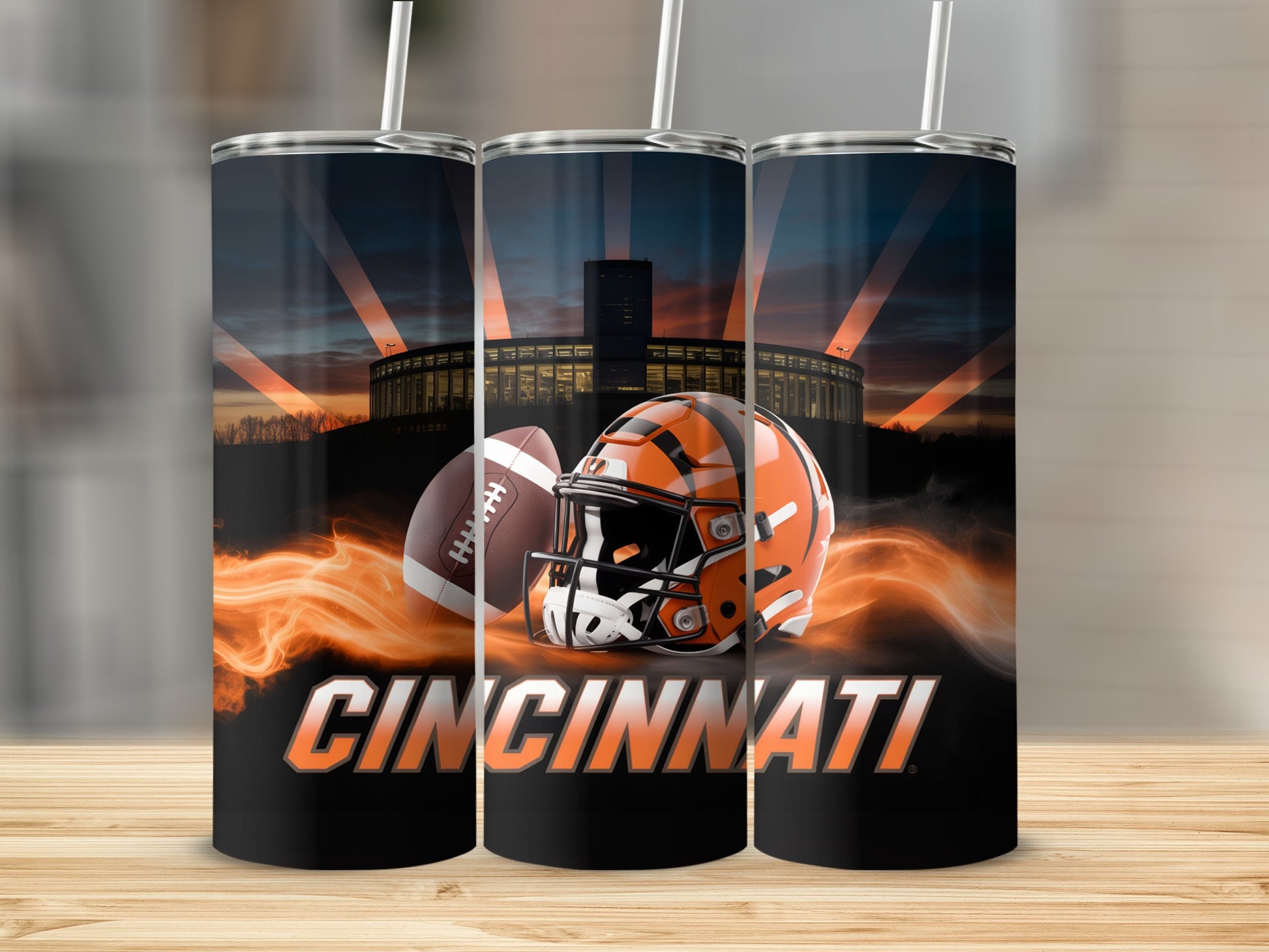 Cincinnati Bengals football helmet and ball with stadium at sunset.