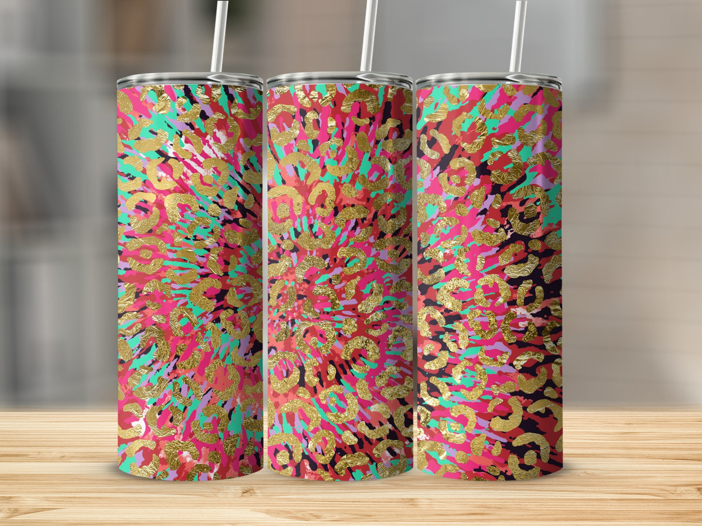 Three tumblers with a pink, teal, and purple abstract leopard print with gold foil accents.