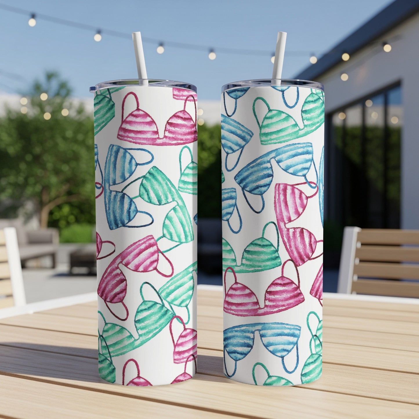 Two tumblers with a watercolor pattern of pink, blue, and green bikini tops.