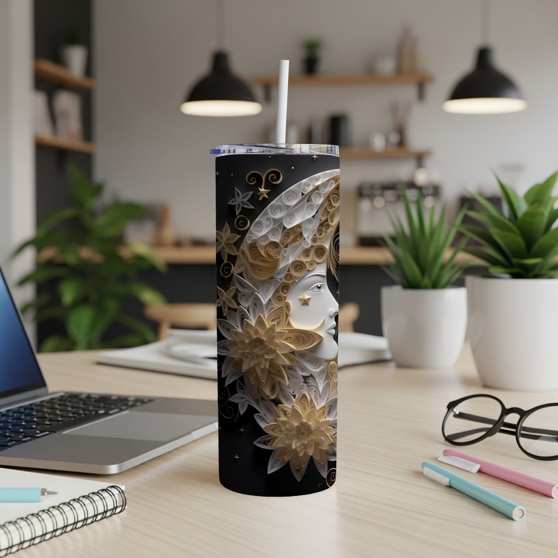 Black tumbler with a detailed celestial face design and gold floral accents.