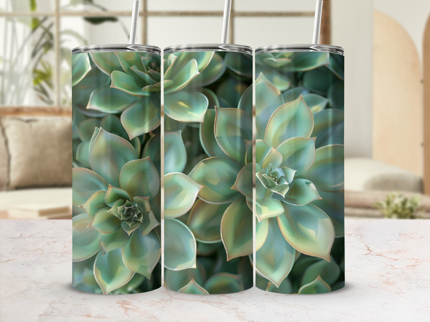 Three tumblers with succulent plant design on a marble surface.