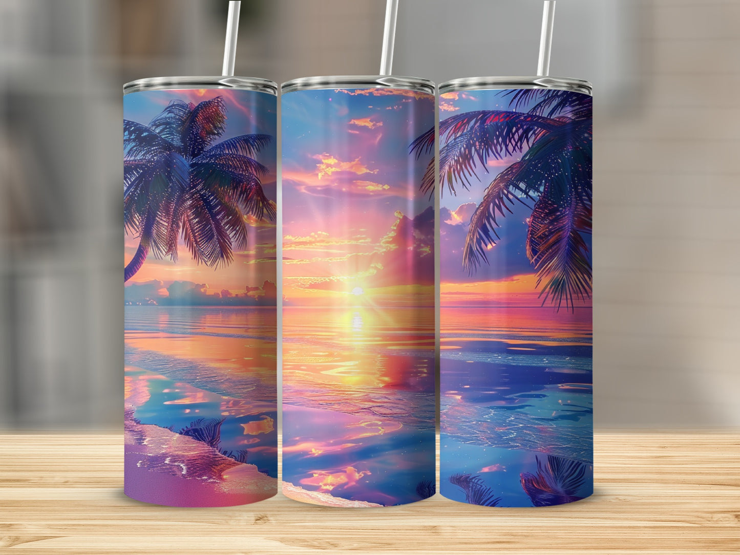 Three tumblers with a vibrant sunset over a tropical ocean scene.
