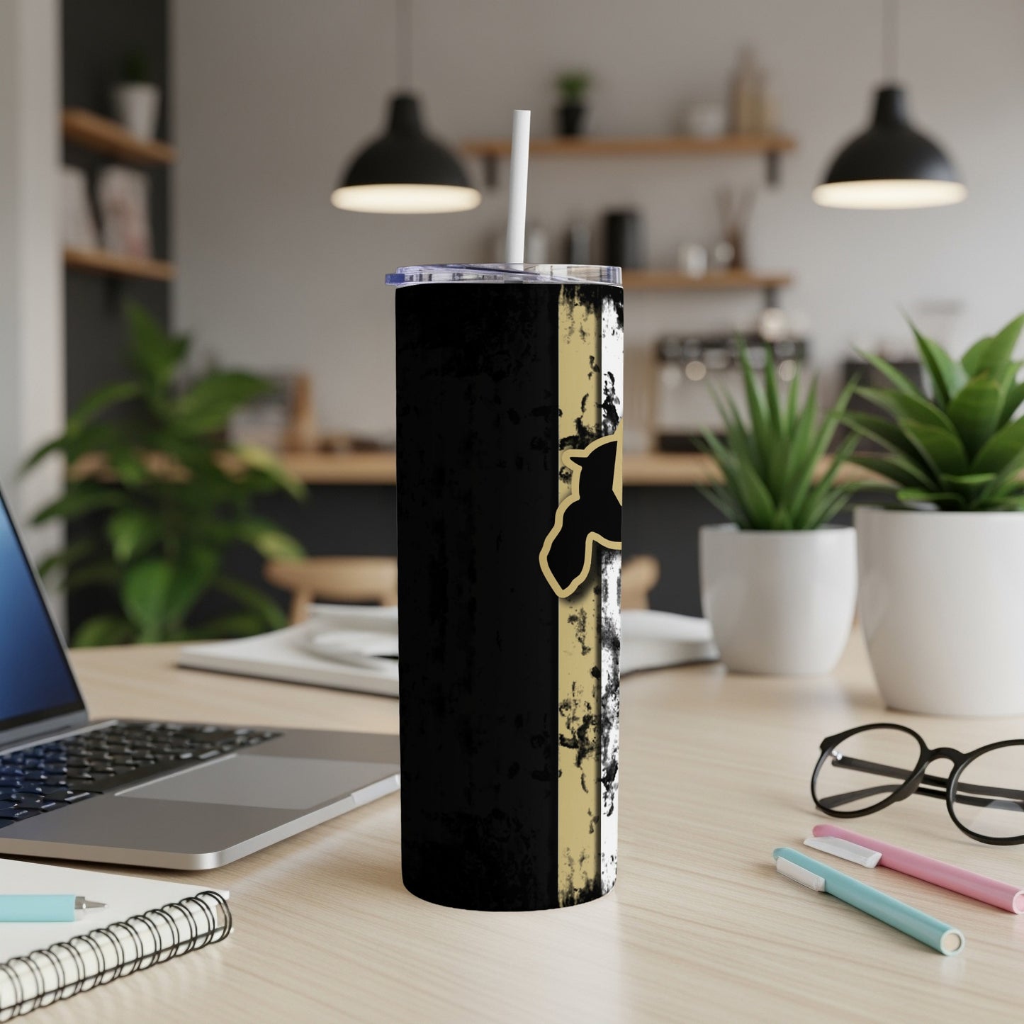 Black tumbler with distressed gold and white stripe design and a white straw.