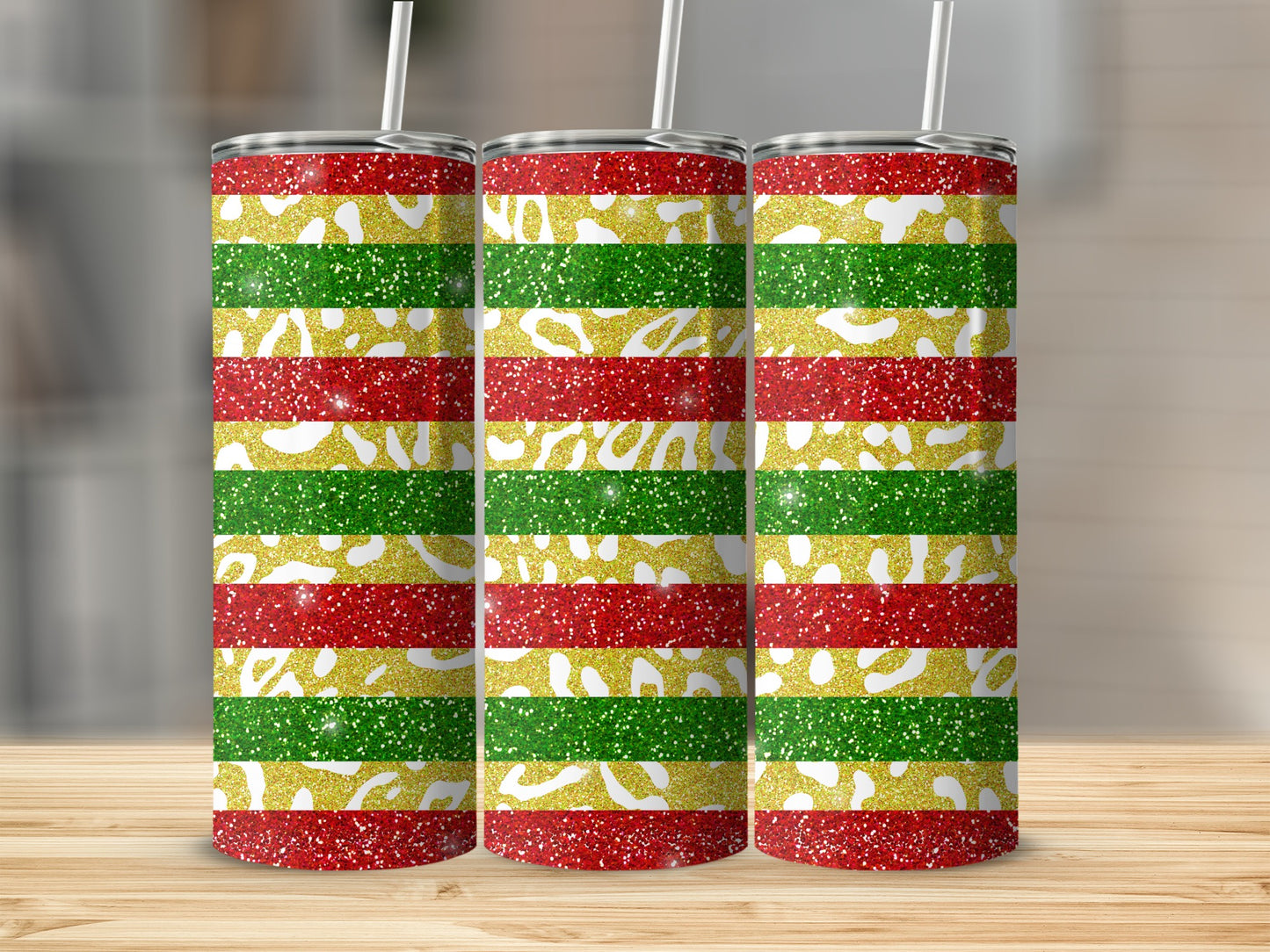 Three glittery tumblers with red, green, and gold horizontal stripes.