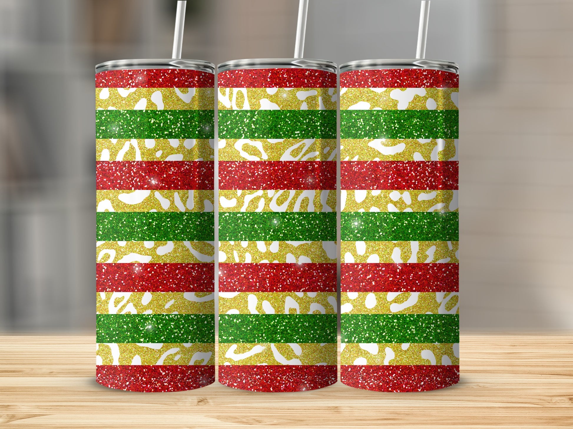 Three glittery tumblers with red, green, and gold horizontal stripes.