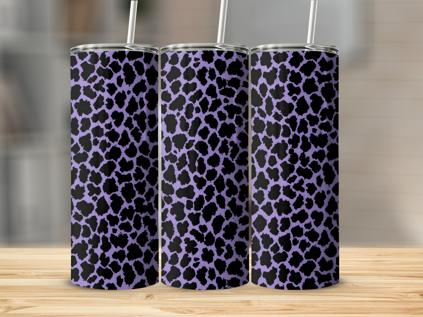 Three tall tumblers with a purple and black abstract animal print pattern.