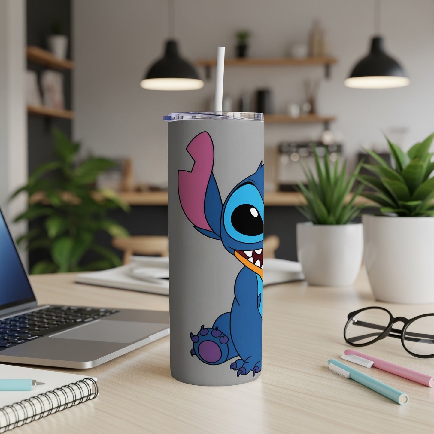 Blue Stitch character on a grey tumbler with a white straw.